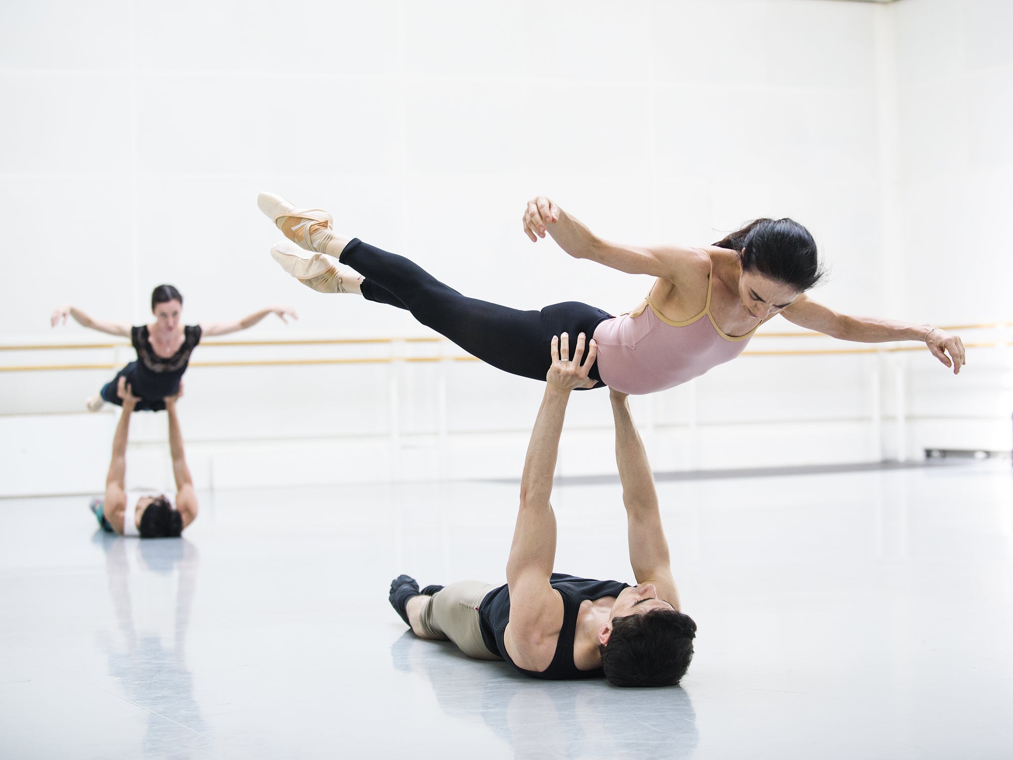 A Ballerina being held in the air while rehearsing for Woolf Works at Fonteyn Studio, Royal Opera House.