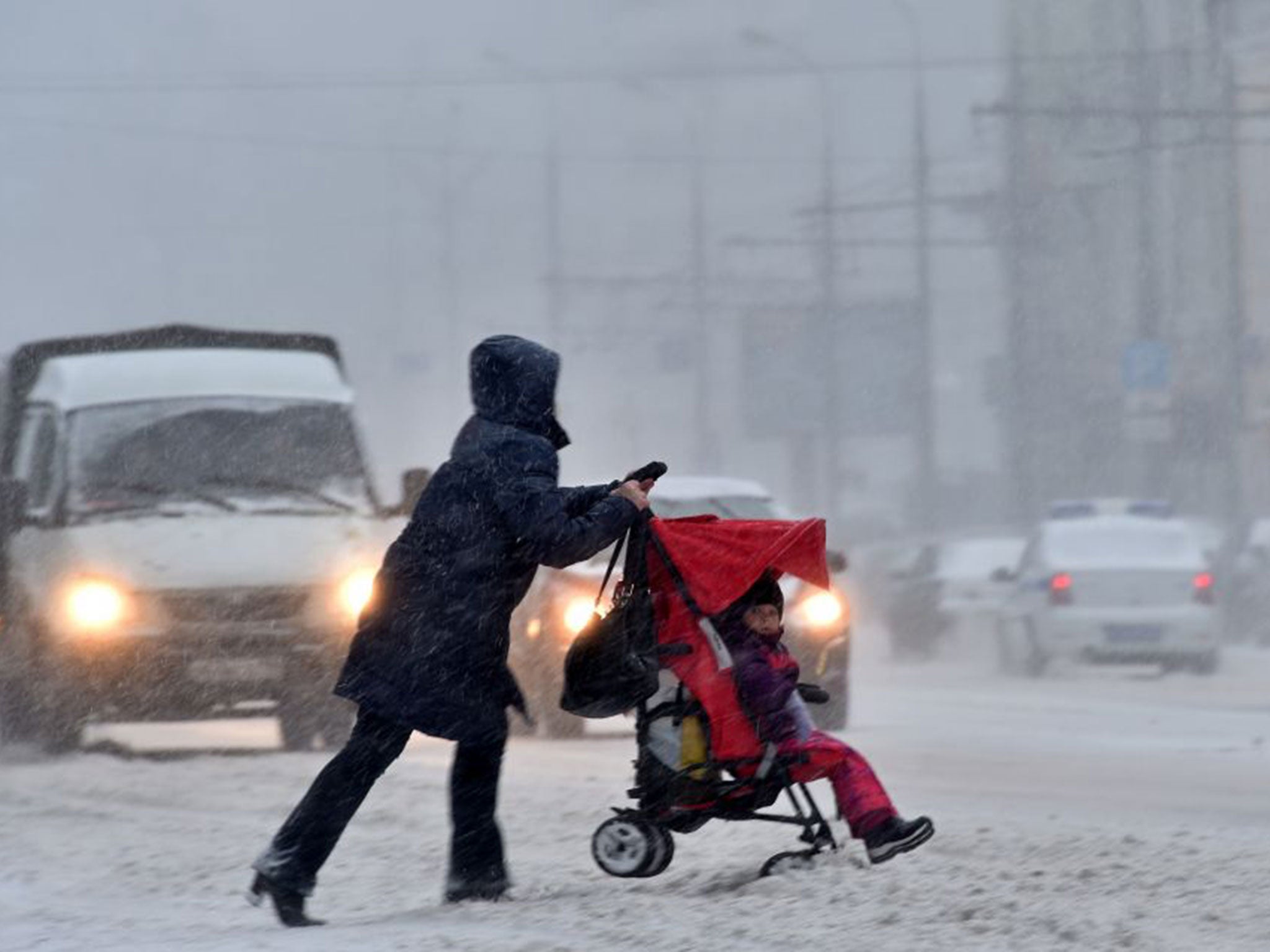 Women pushes pram in Moscow town