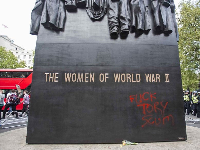 Graffiti on The Women of World War II monument outside of Downing Street, London, following an anti-austerity protest