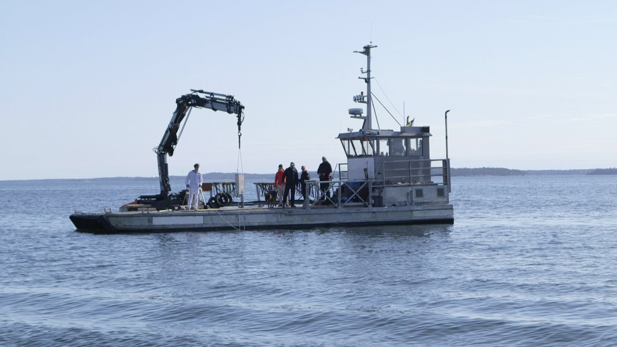 Members of the Swedish Peace and Arbitration Society lower the Singing Sailor into the Baltic Sea