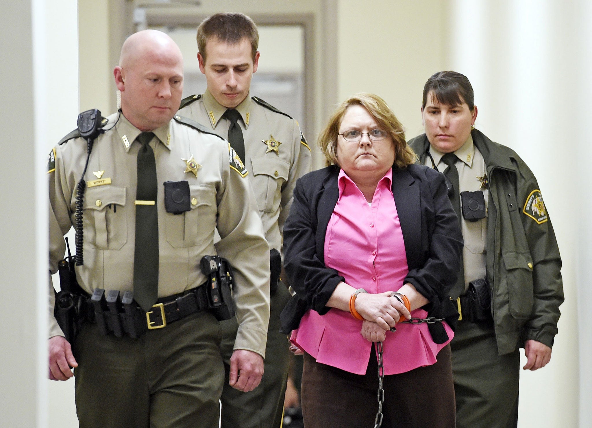 File: Joyce Hardin Garrard is led back to the Etowah County Detention Center in Gadsden, Alabama