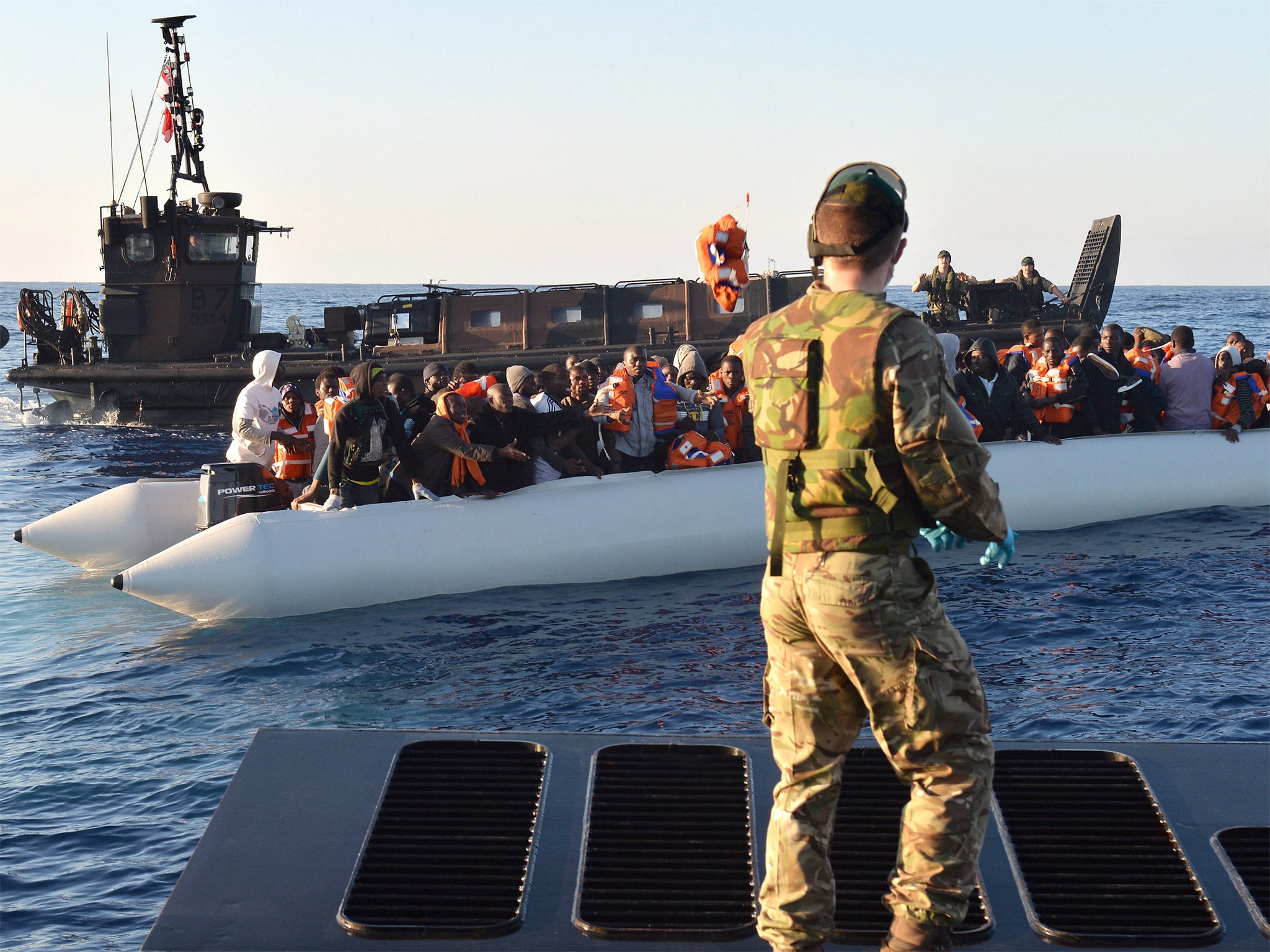 Royal Navy flagship HMS ‘Bulwark’ prepares to bring aboard migrants on Wednesday during its largest rescue operation since being deployed to the Mediterranean earlier this month. Crews on the ship were working to rescue more than 400 people on four 30ft i