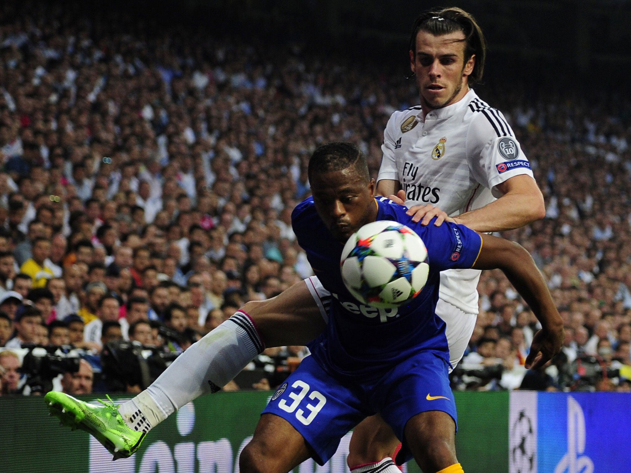 Patrice Evra and Gareth Bale battle for the ball