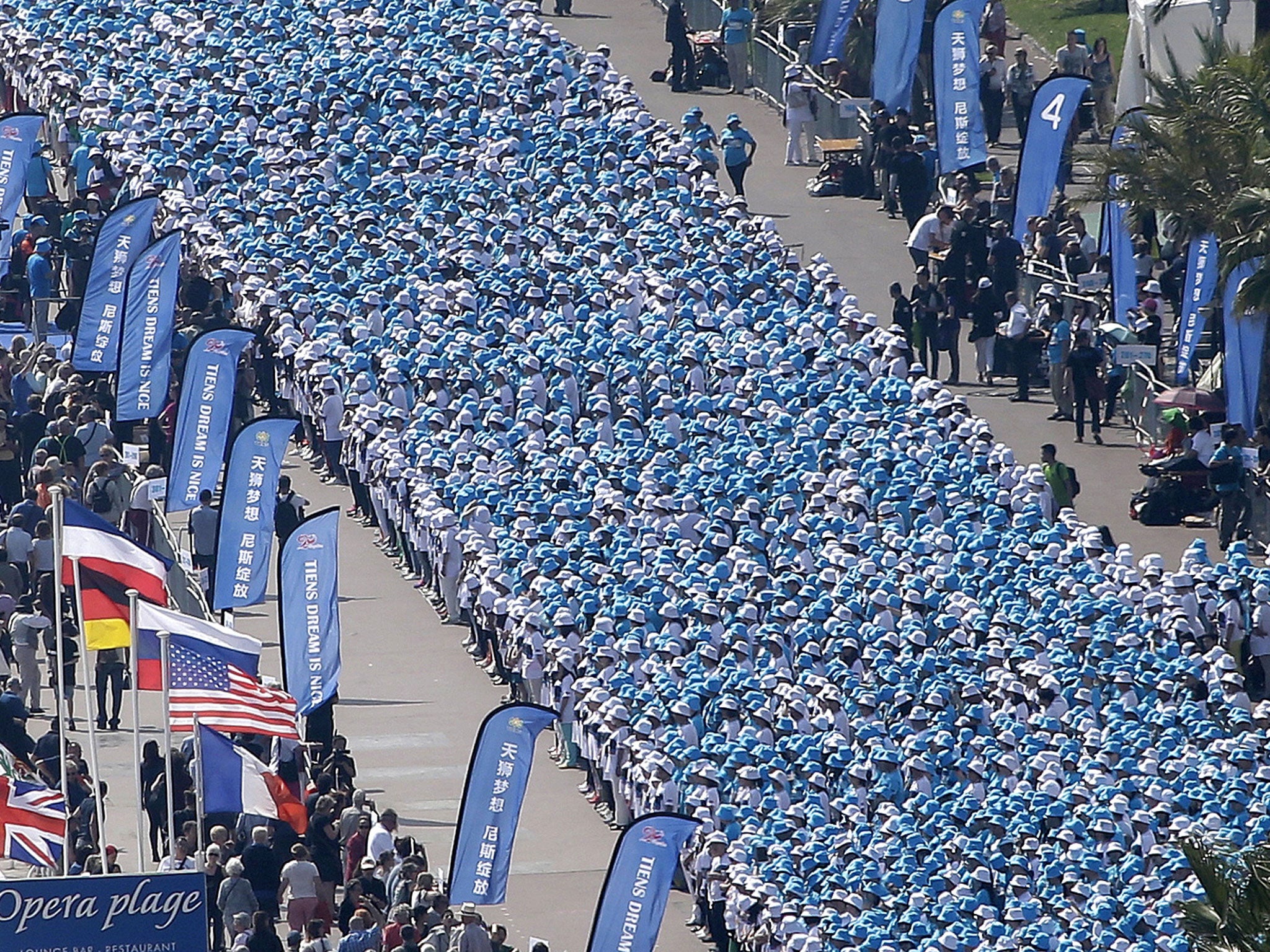 Employees of the TIENS Group, a Chinese company, attend a parade organized by CEO Li Jinyuan as part of a four-day celebration weekend for the 20th anniversary of his company