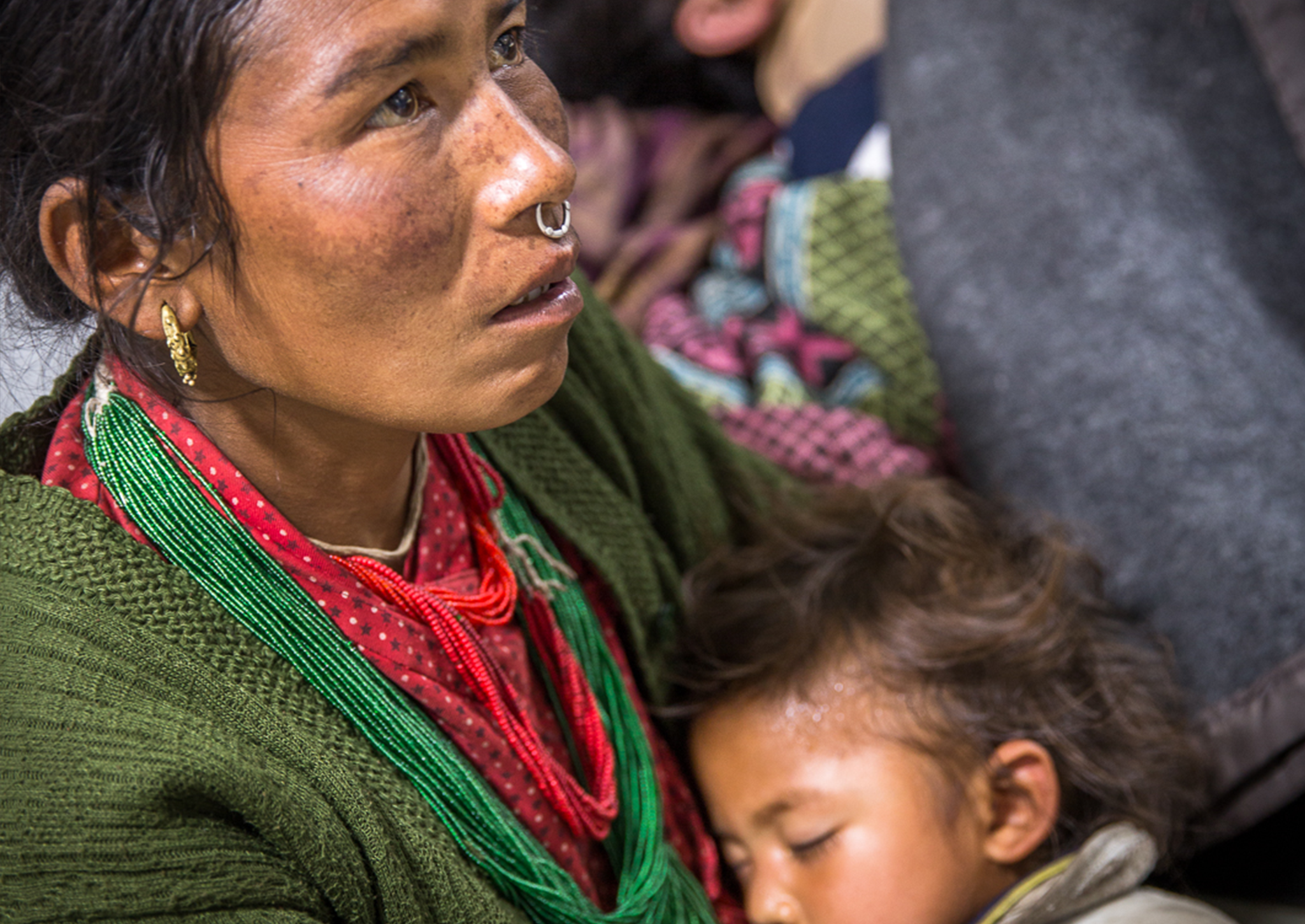 A Nepalese woman cradles her child after the quake