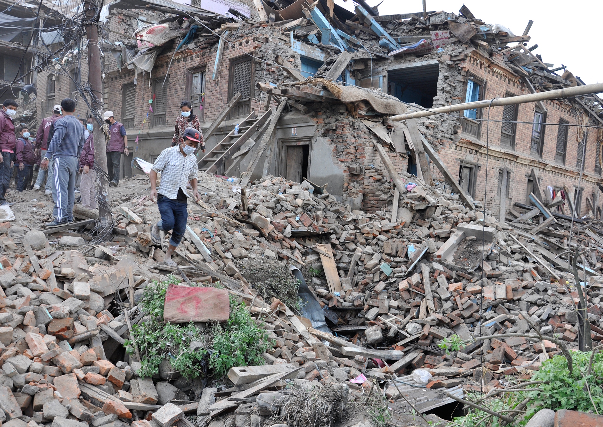 Rescue workers arrive at a collapsed building after Nepal's latest earthquake