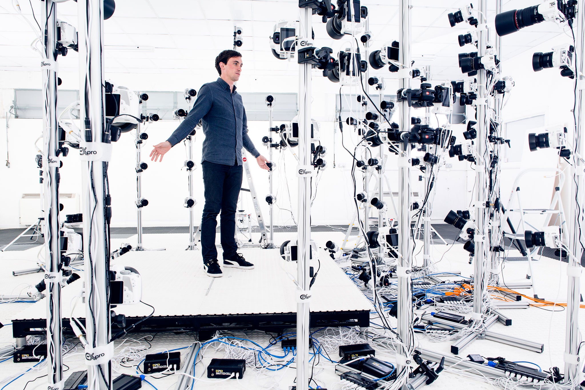 The writer stands in front of 150 cameras, where models are captured for use in virtual simulations