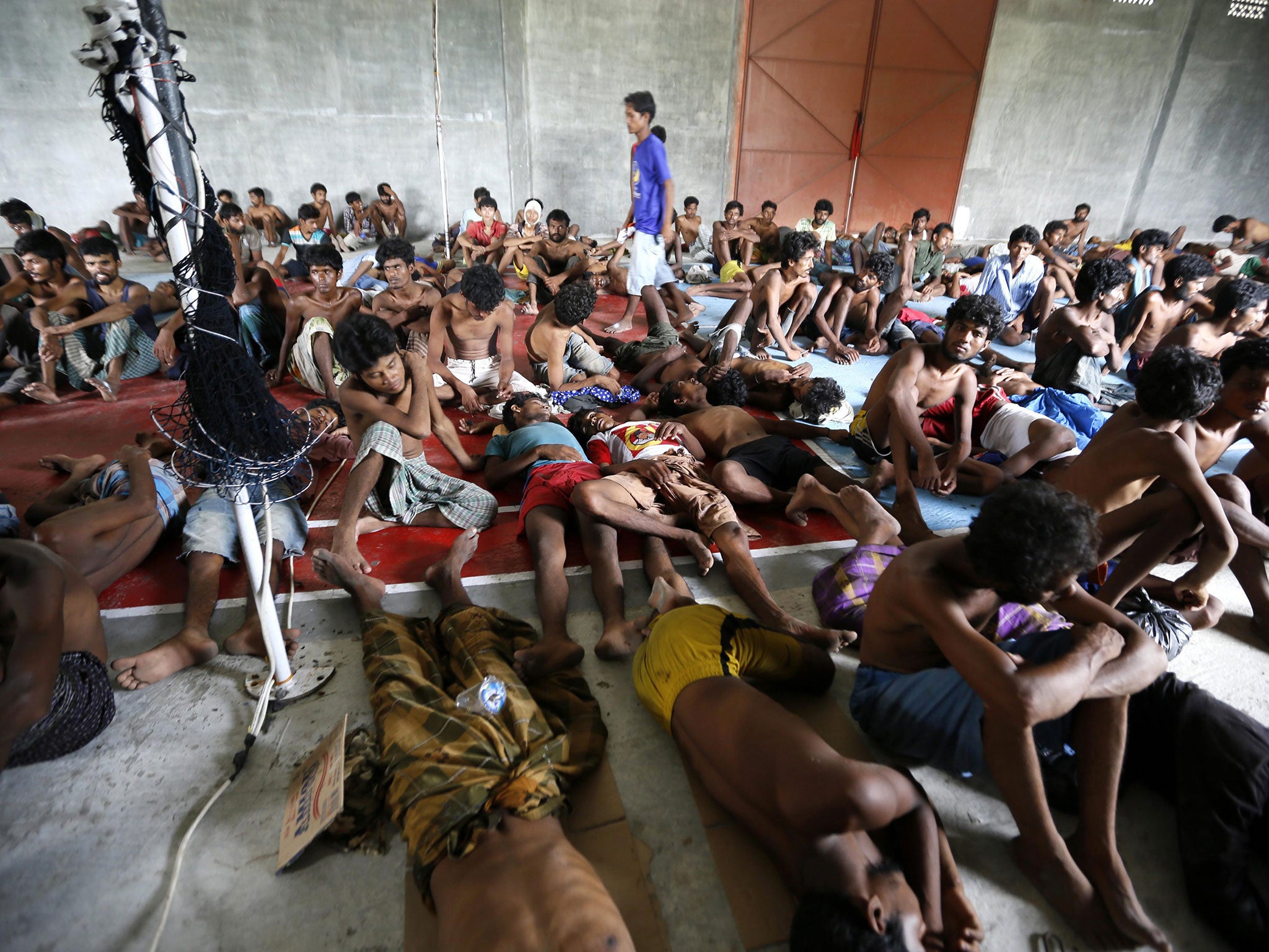 A refugee take a rest after being save from the sea in Indonesia