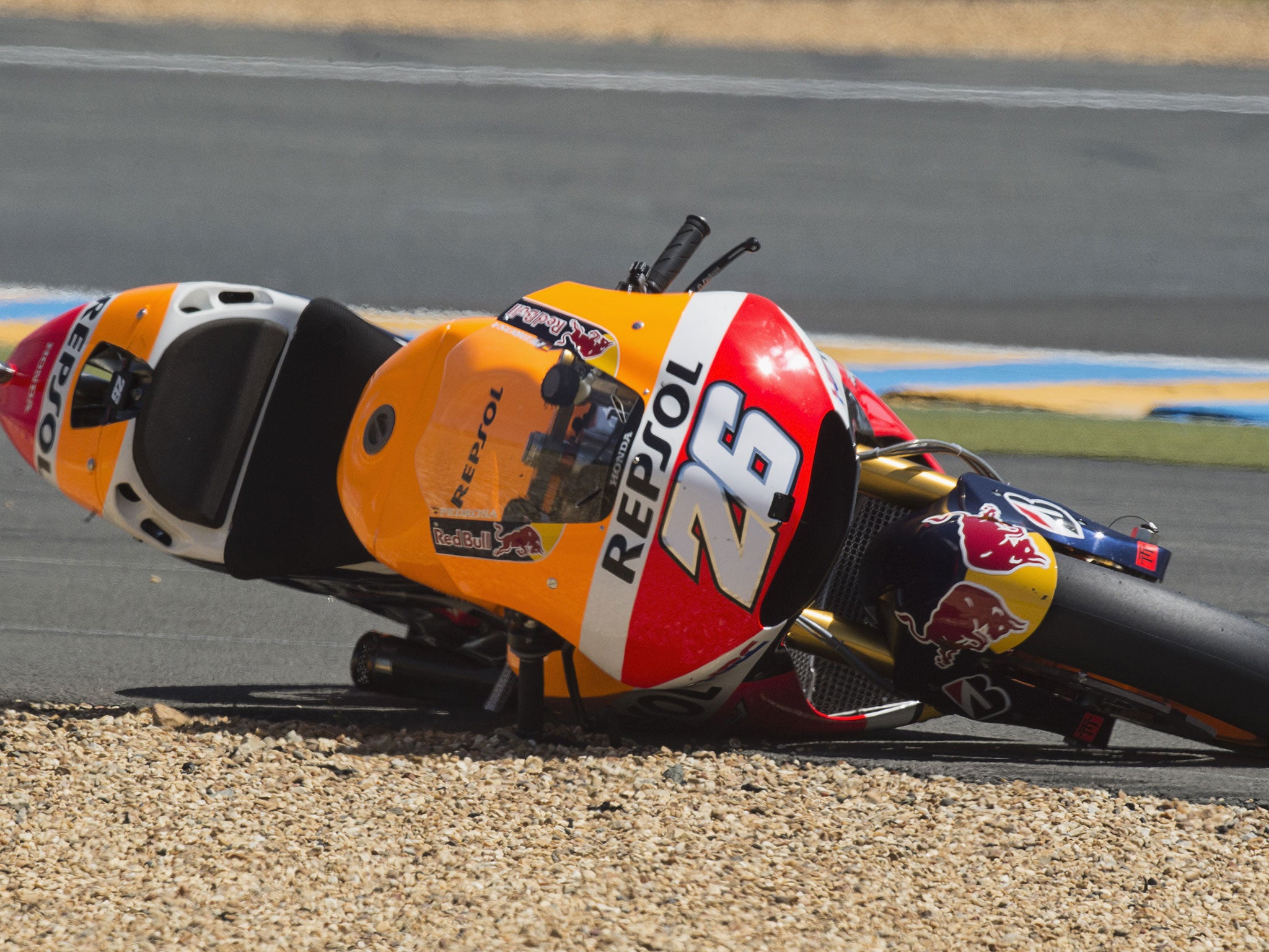 Dani Pedrosa's Honda lies stricken on the edge of the gravel trap