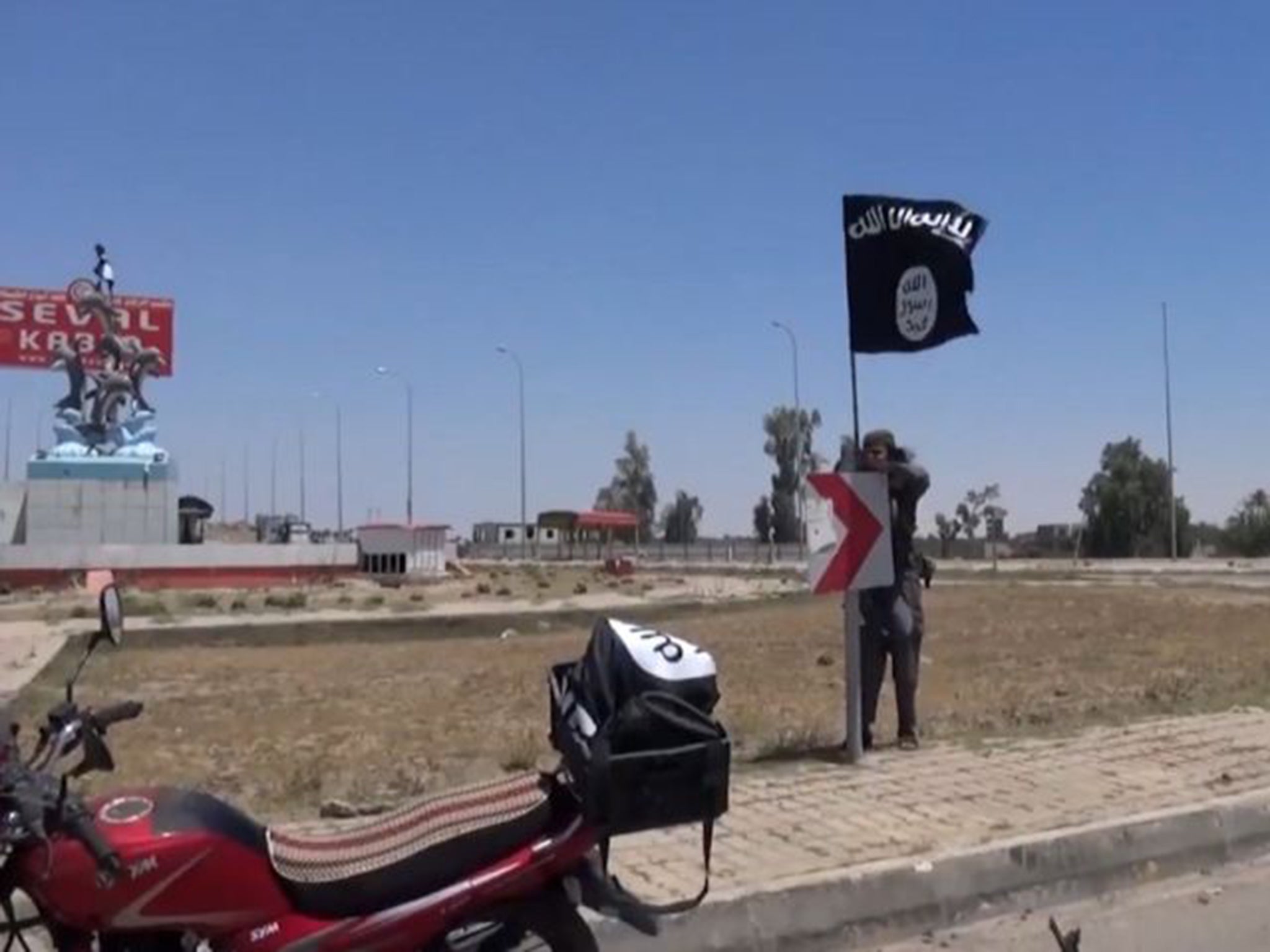 Footage appears to show an Isis fighter displaying the group’s flag in Ramadi