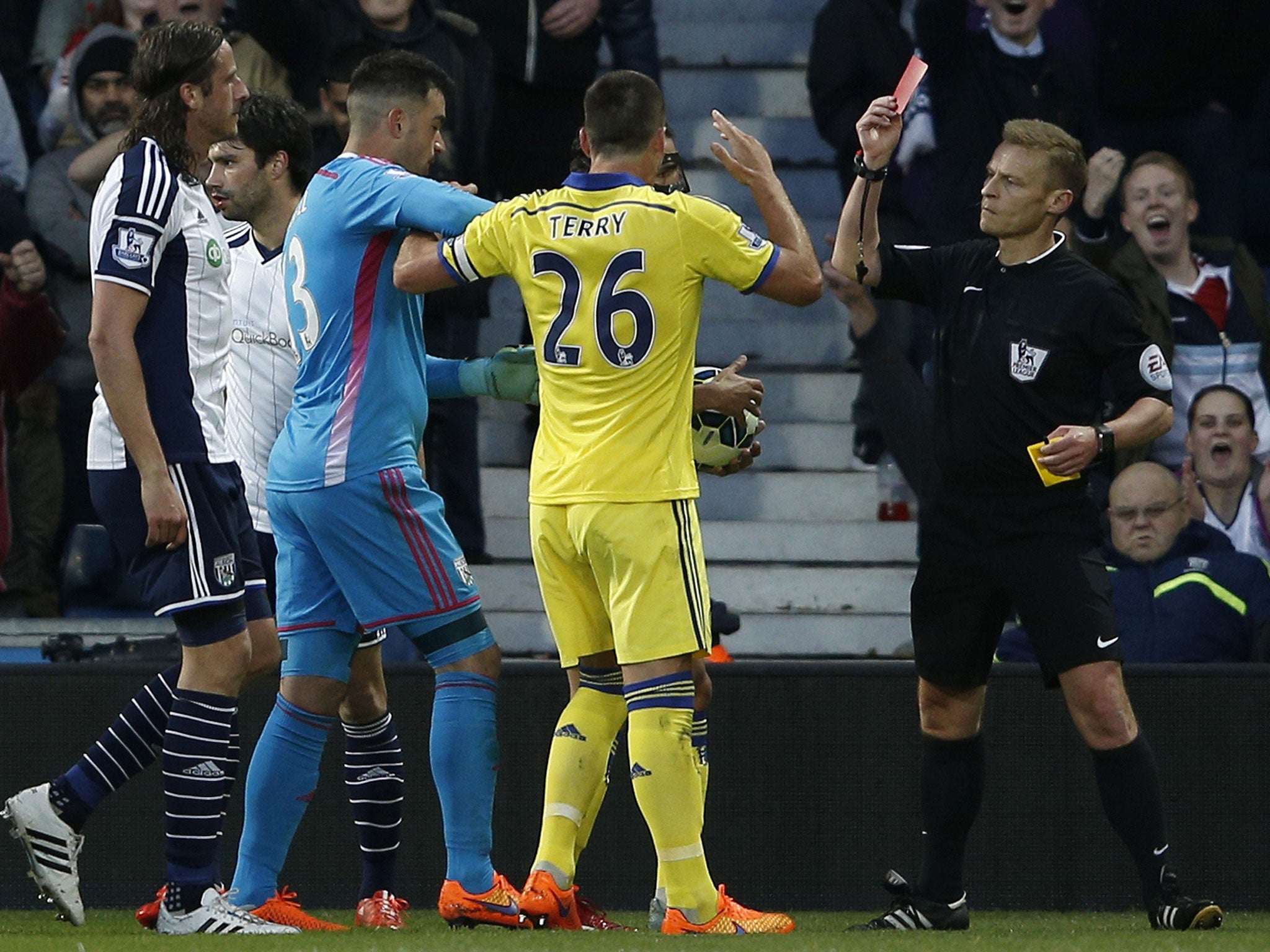 Mike Jones issues a red card to Cesc Fabregas