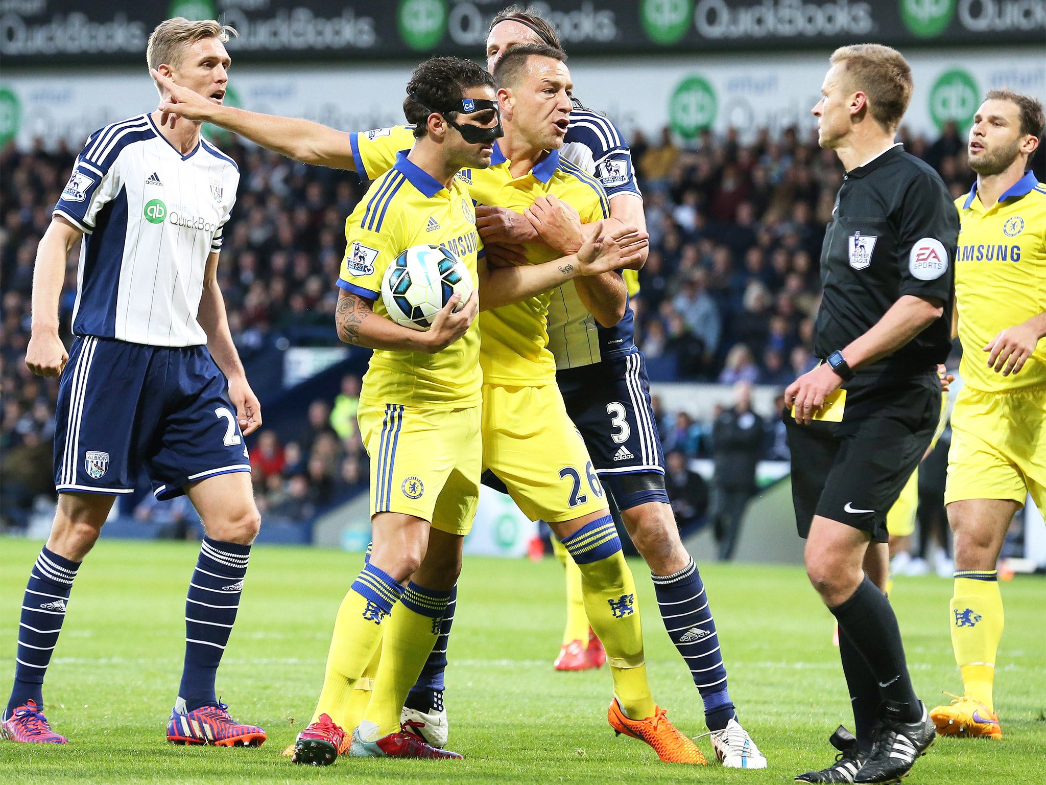 Cesc Fabregas (masked) remonstrates with referee Mike Jones after being sent off on Monday