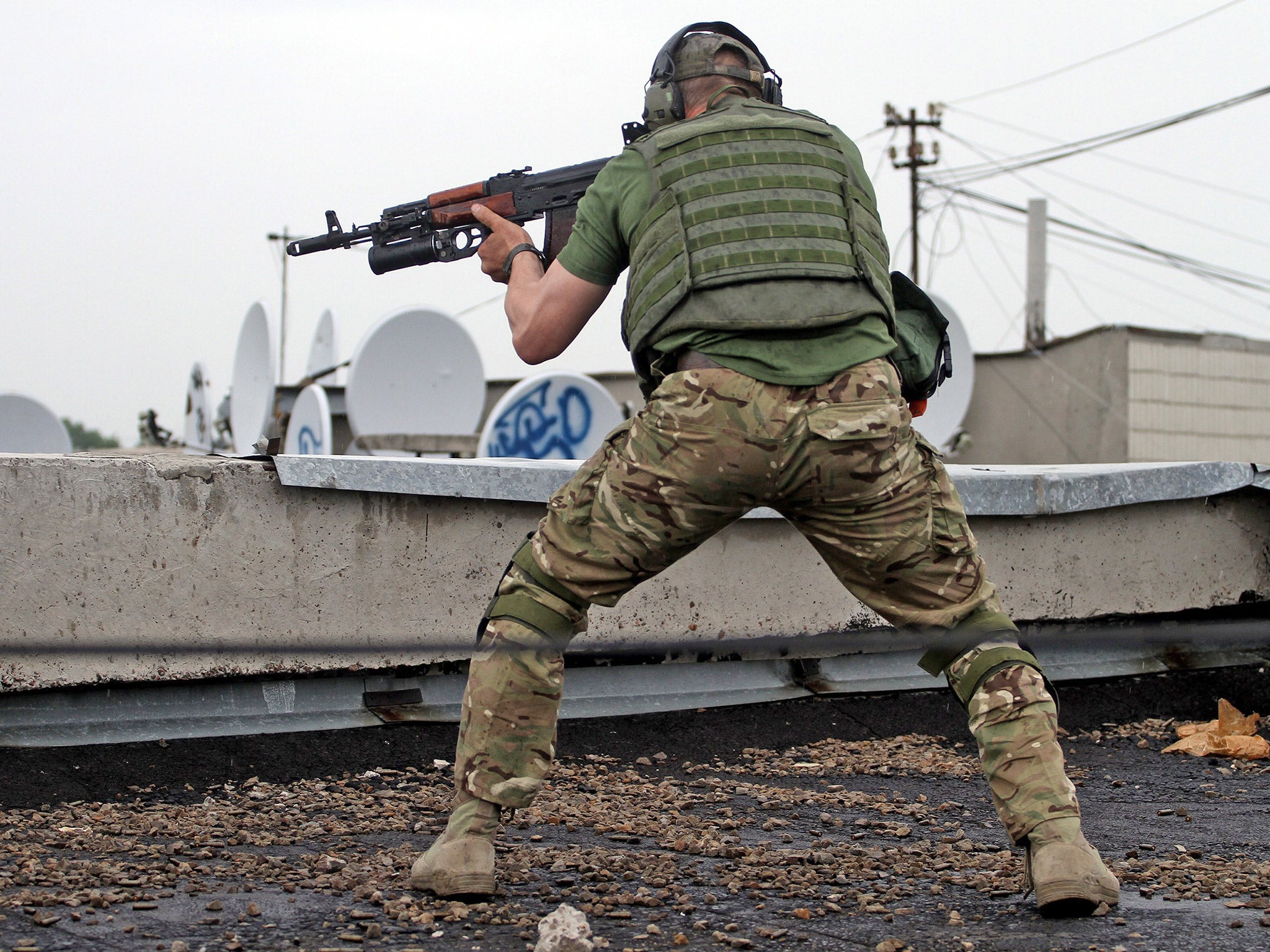 Pro-Russia militant fires his weapon in the eastern Ukrainian city of Luhansk. File photo