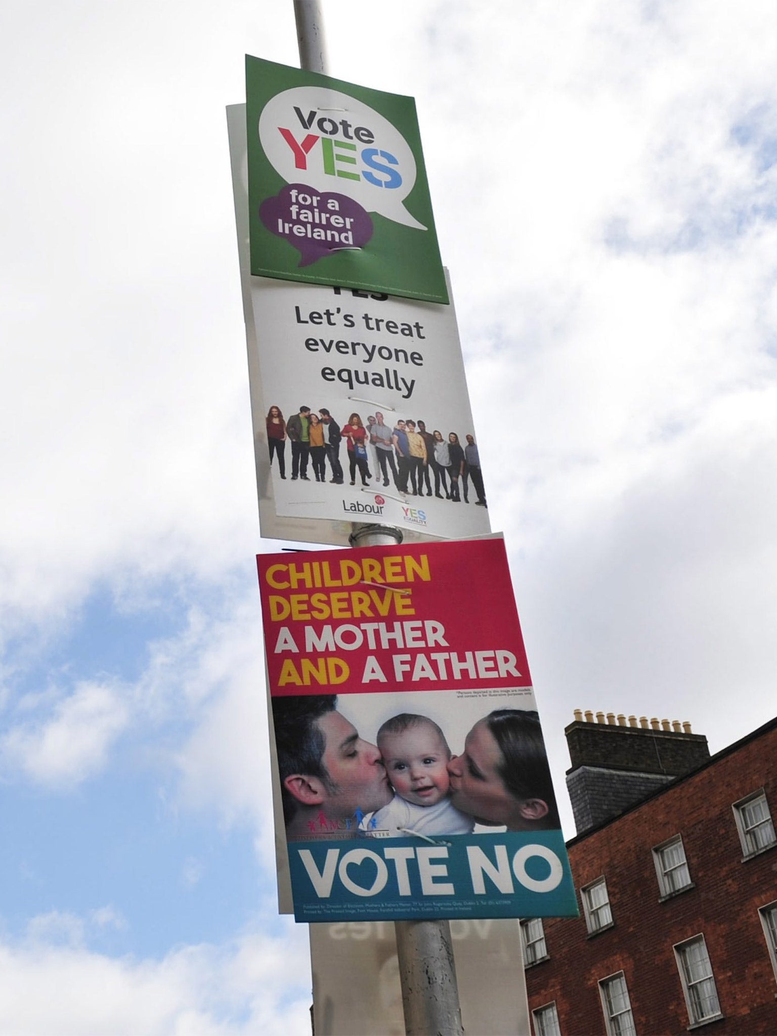 'Yes' and 'no' vote posters hanging from a lampost ahead of the referendum, in Dublin