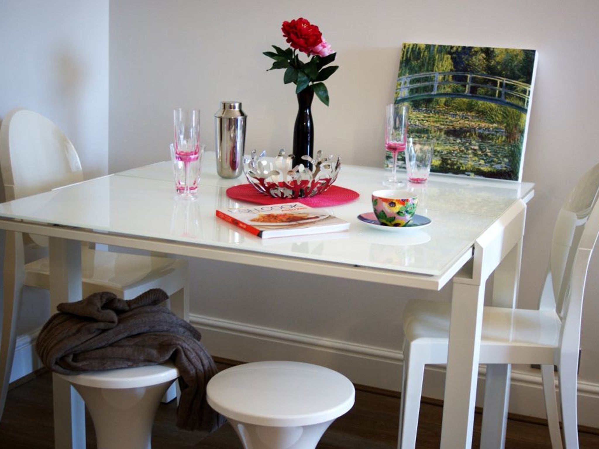 An extendable dining table from Dwell, Habitat’s Tam Tam stools and Philippe Starck Kartell Victoria Ghost Chairs.