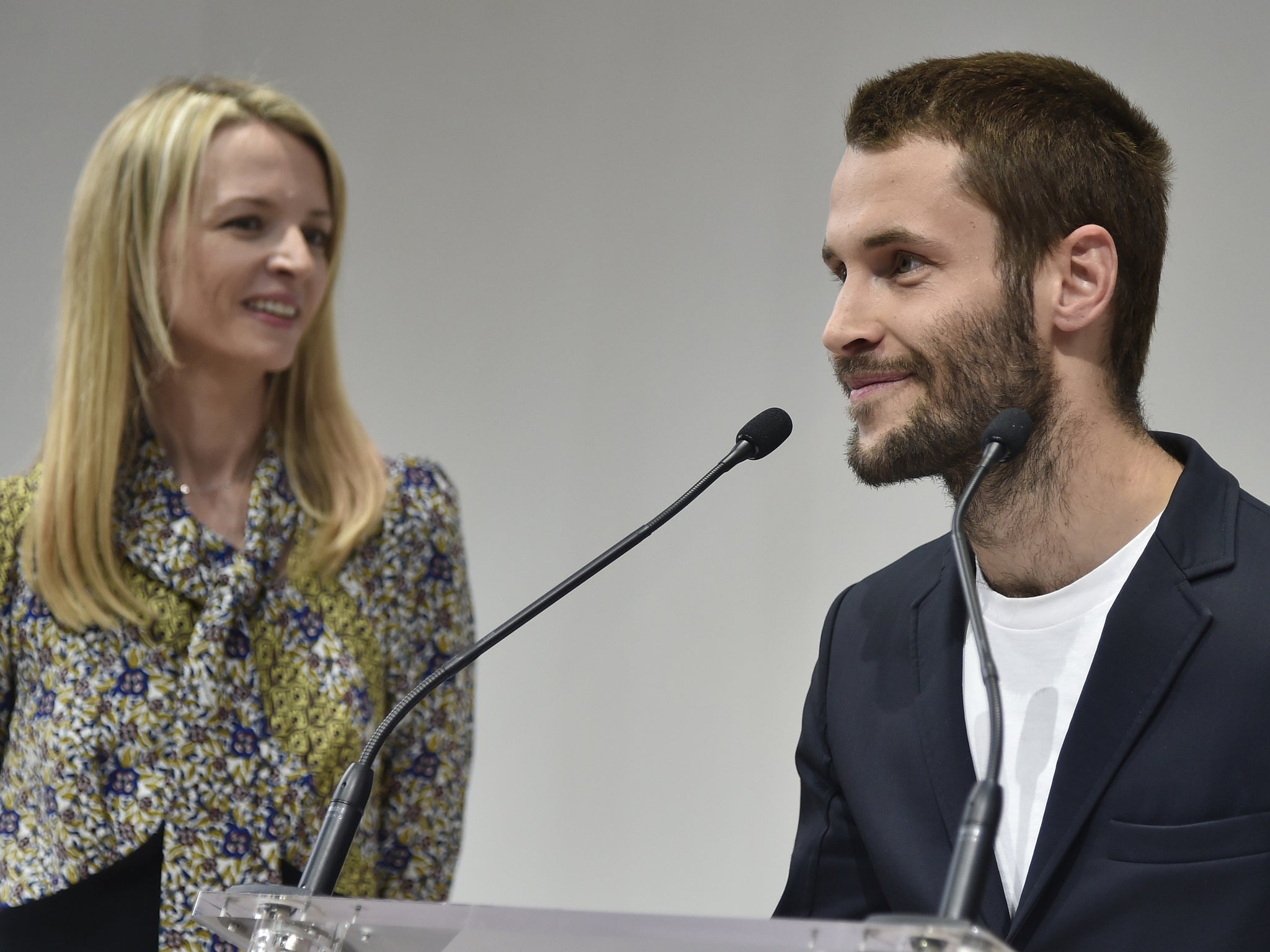 Delphine Arnault (C) looks at Simon Porte of 'Jacquemus' (R) after giving him the Special prize of the first LVMH young fashion designer awards