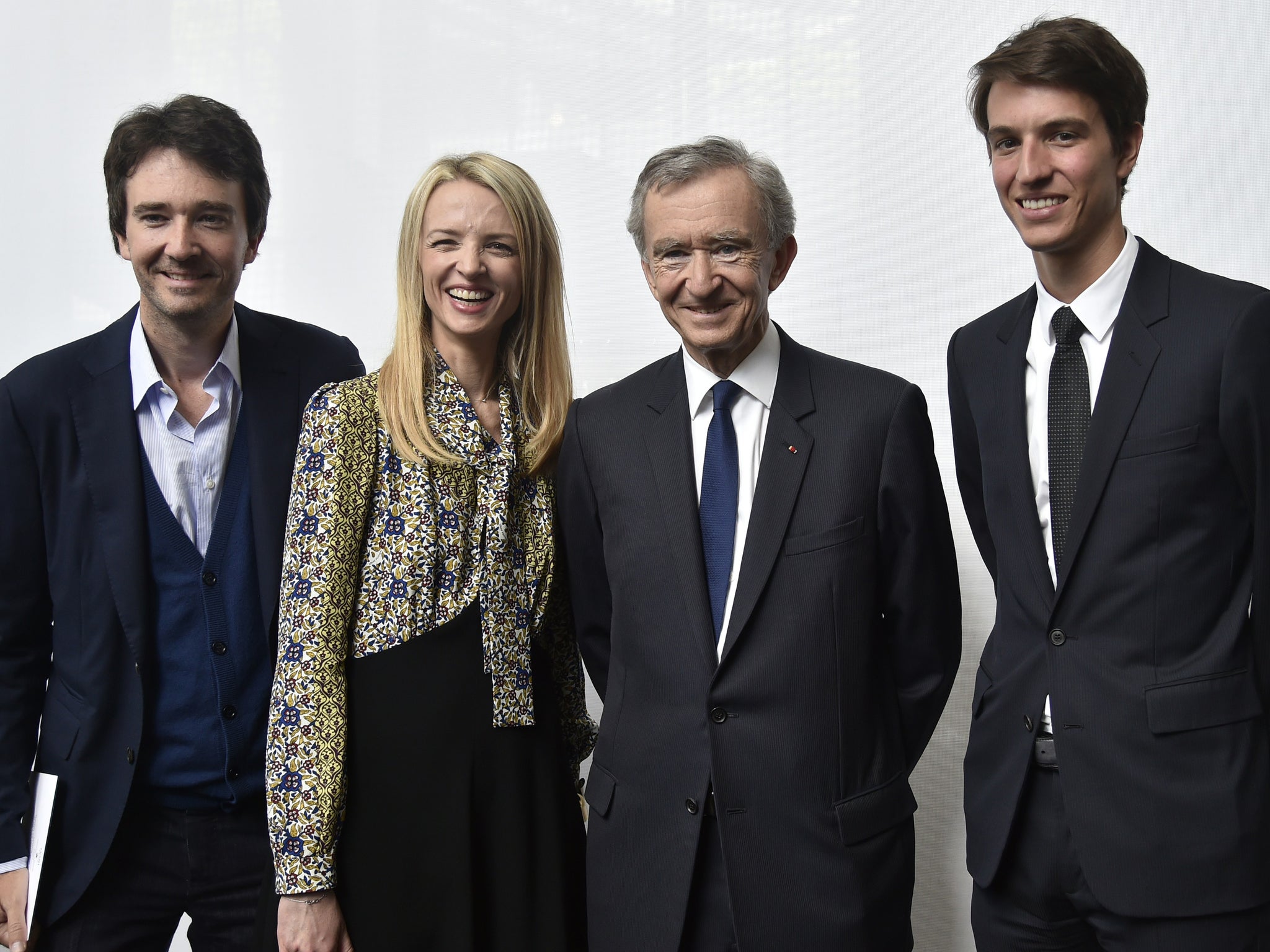 LVMH Chairman and CEO Bernard Arnault (2nd R) poses with his children Delphine (2nd L) Antoine (L) and Alexandre (R) during the first LVMH young fashion designer award ceremony in Paris