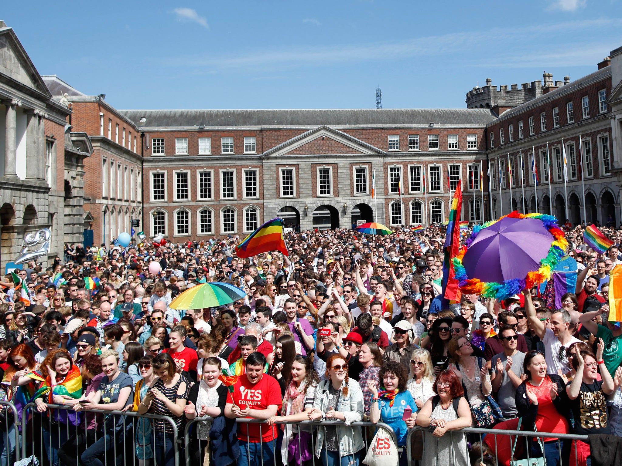 In the courtyard in front of Dublin Castle hundreds of men, women and children draped in rainbow flags hugged, cheered and cried as Ireland legalised same sex marriage