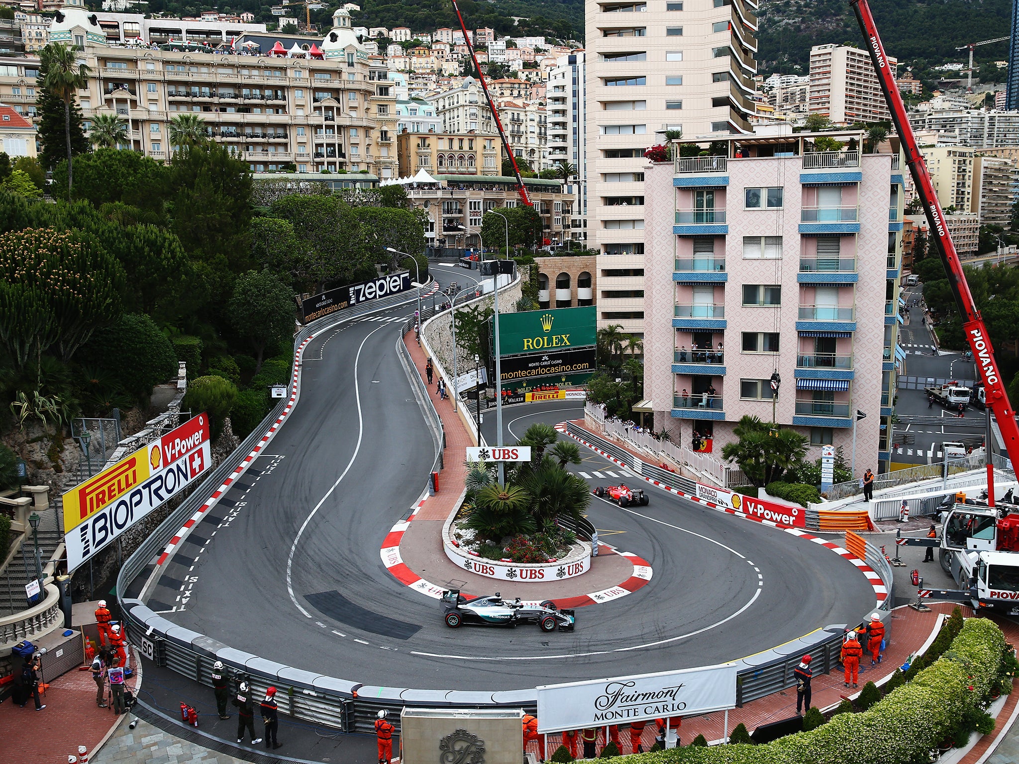 Hamilton follows a Ferrari through the Lowe's hairpin on his way to pole