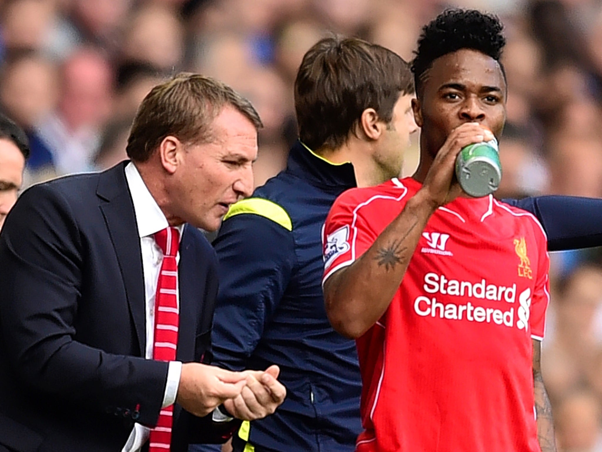 Liverpool manager Brendan Rodgers (left) with Raheem Sterling