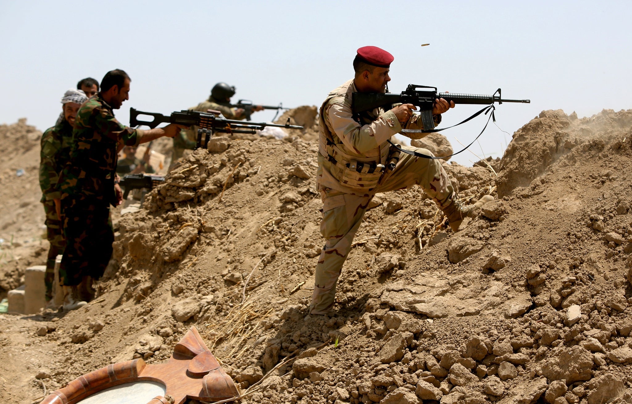 Iraqi forces fire at Isis militants, as they launch a counter offensive to take back Ramadi