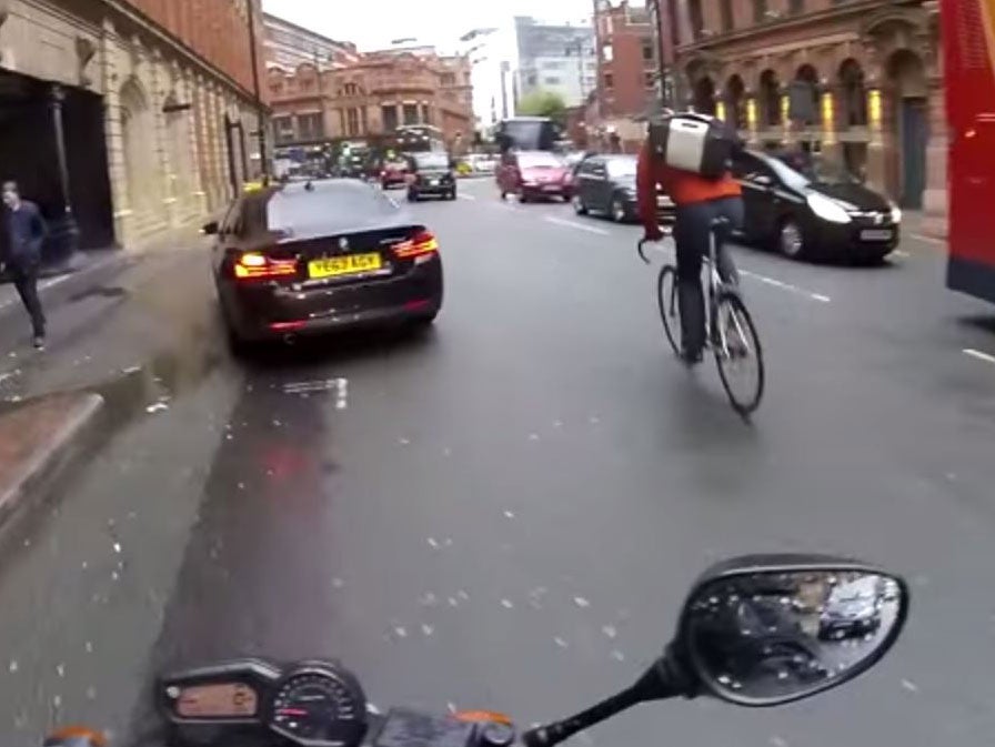 The video shows the moment a cyclist ran a red light and carried on into the side of a double-decker bus