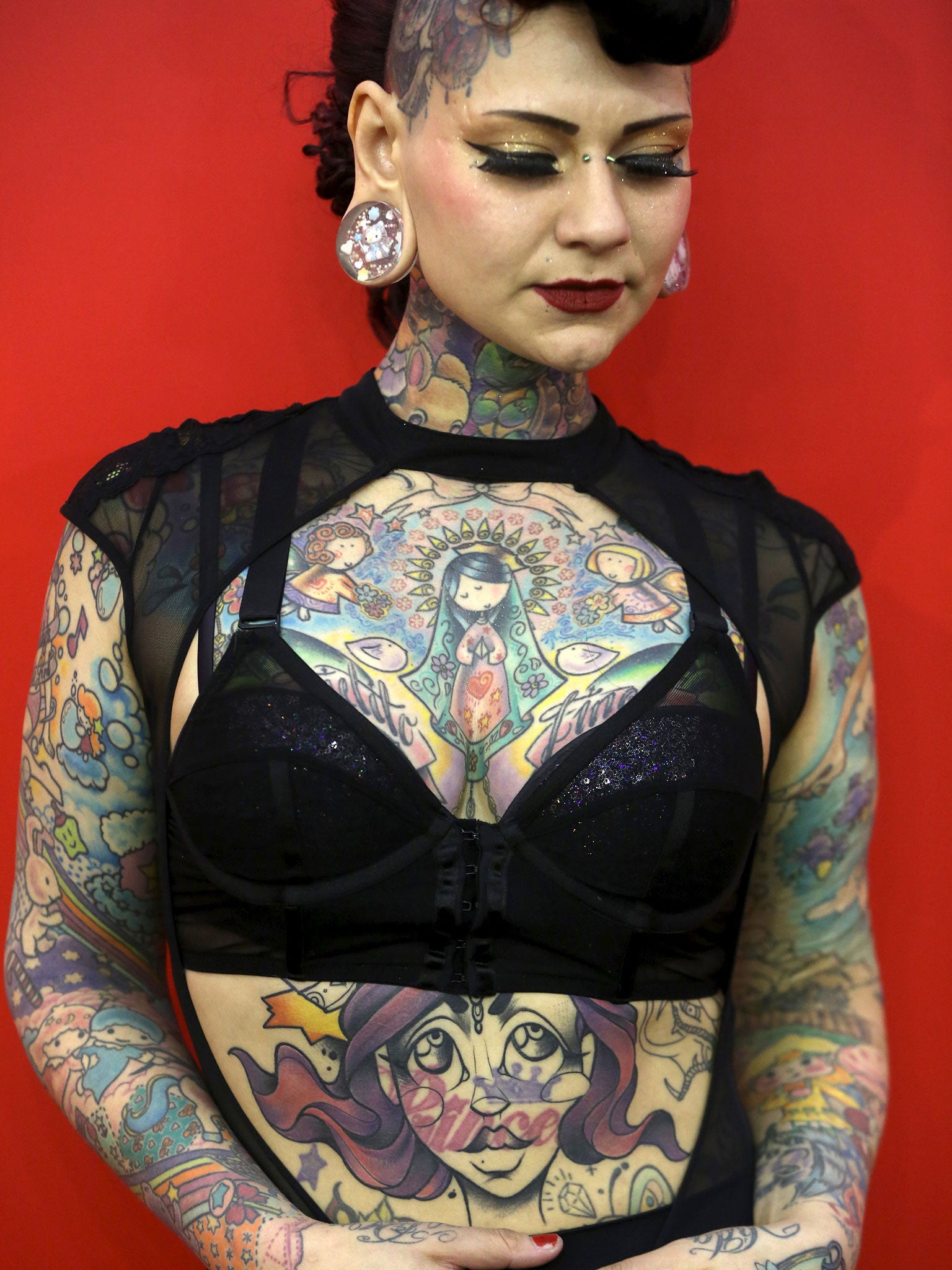 Model Aima Indigo poses for a portrait during the Great British Tattoo Show in Alexandra Palace