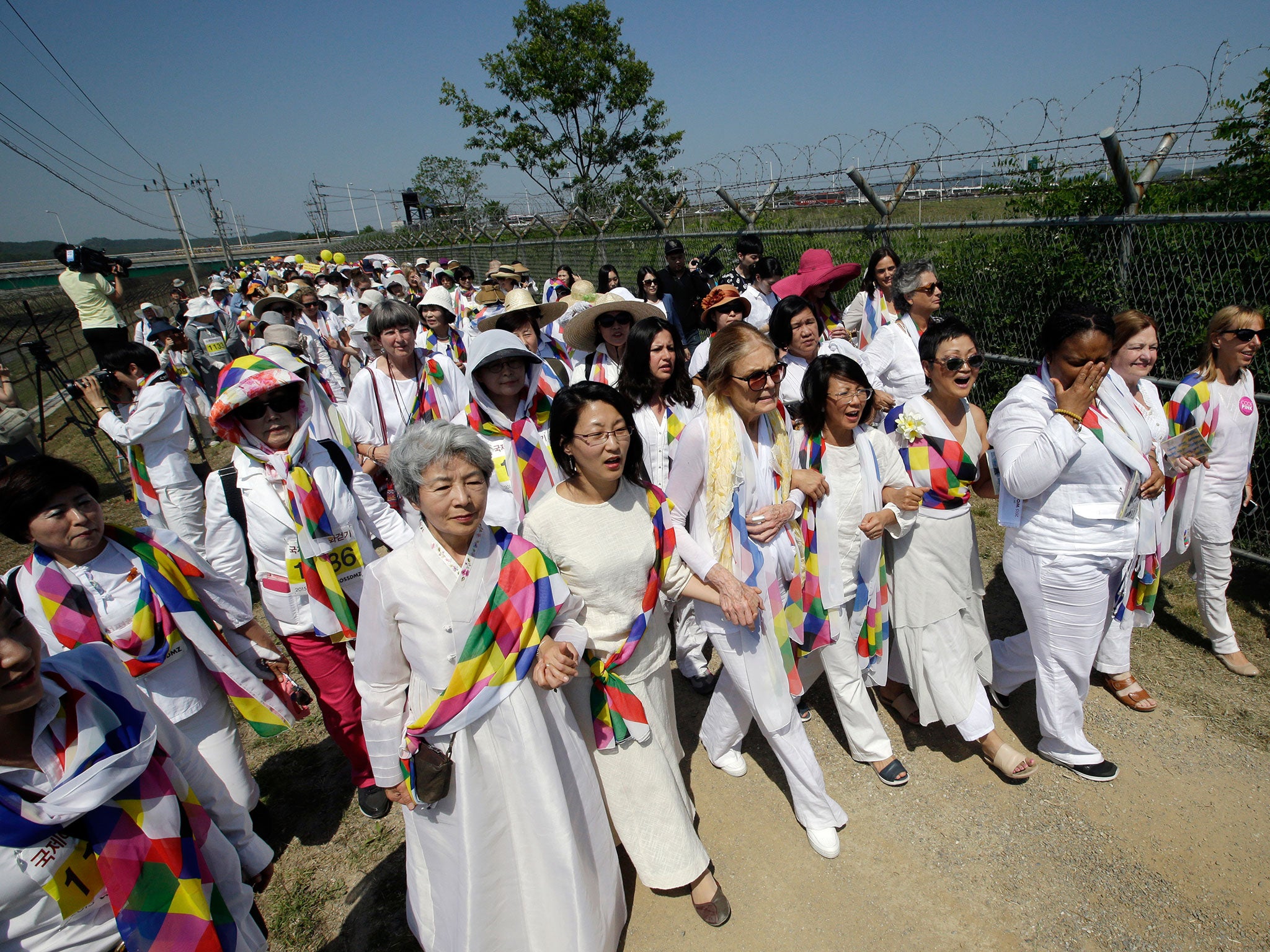 The US activist Gloria Steinem, centre, leads the WomenCrossDMZ marchers