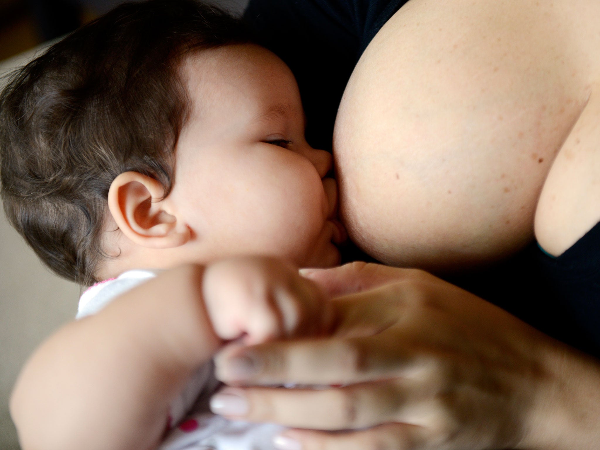 A woman breastfeeds her child