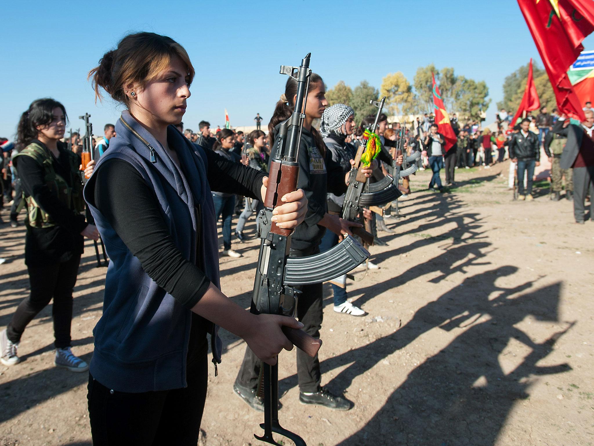 Syrian-Kurdish women and members of the Popular Protection Units (YPG). The road that leads directly to Raqqa, the Isis Syrian capital, is currently threatened by a pincer movement of Kurds