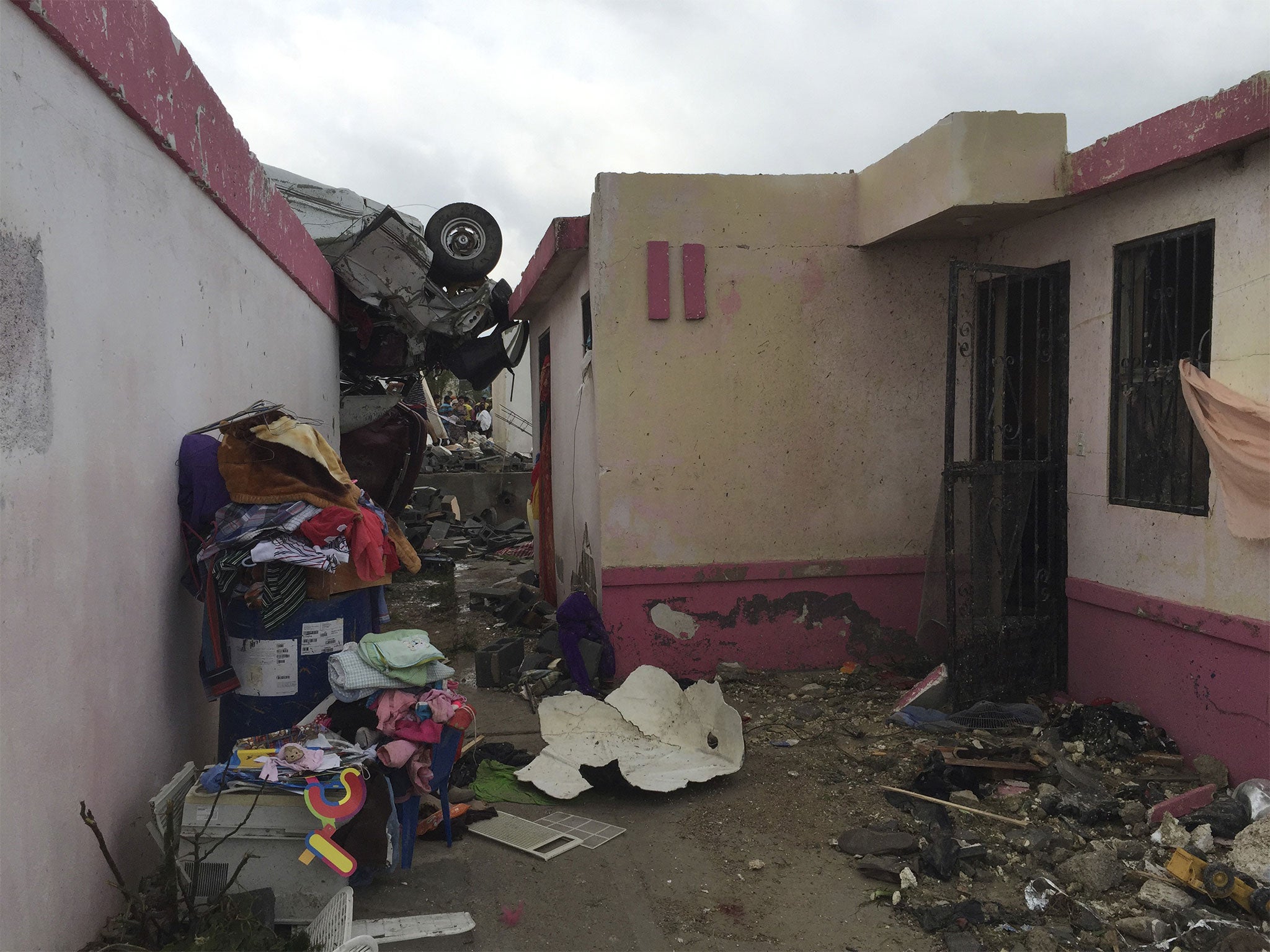 A vehicle lies on top of a building in Ciudad Acuna