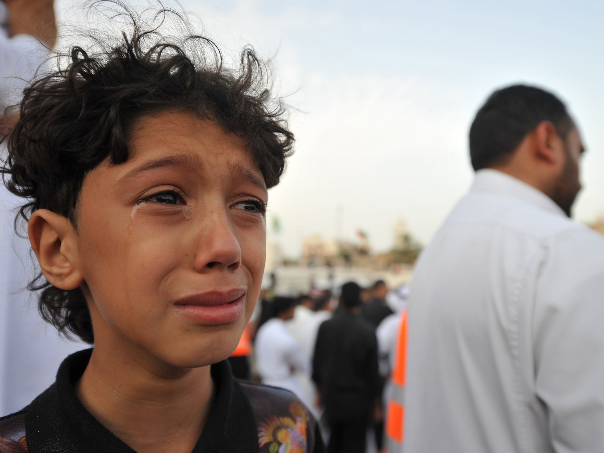 A young relative weeps during a mass funeral held on May 25 in the village of Kudeih, for the victims of a mosque bombing carried out by the Islamic State