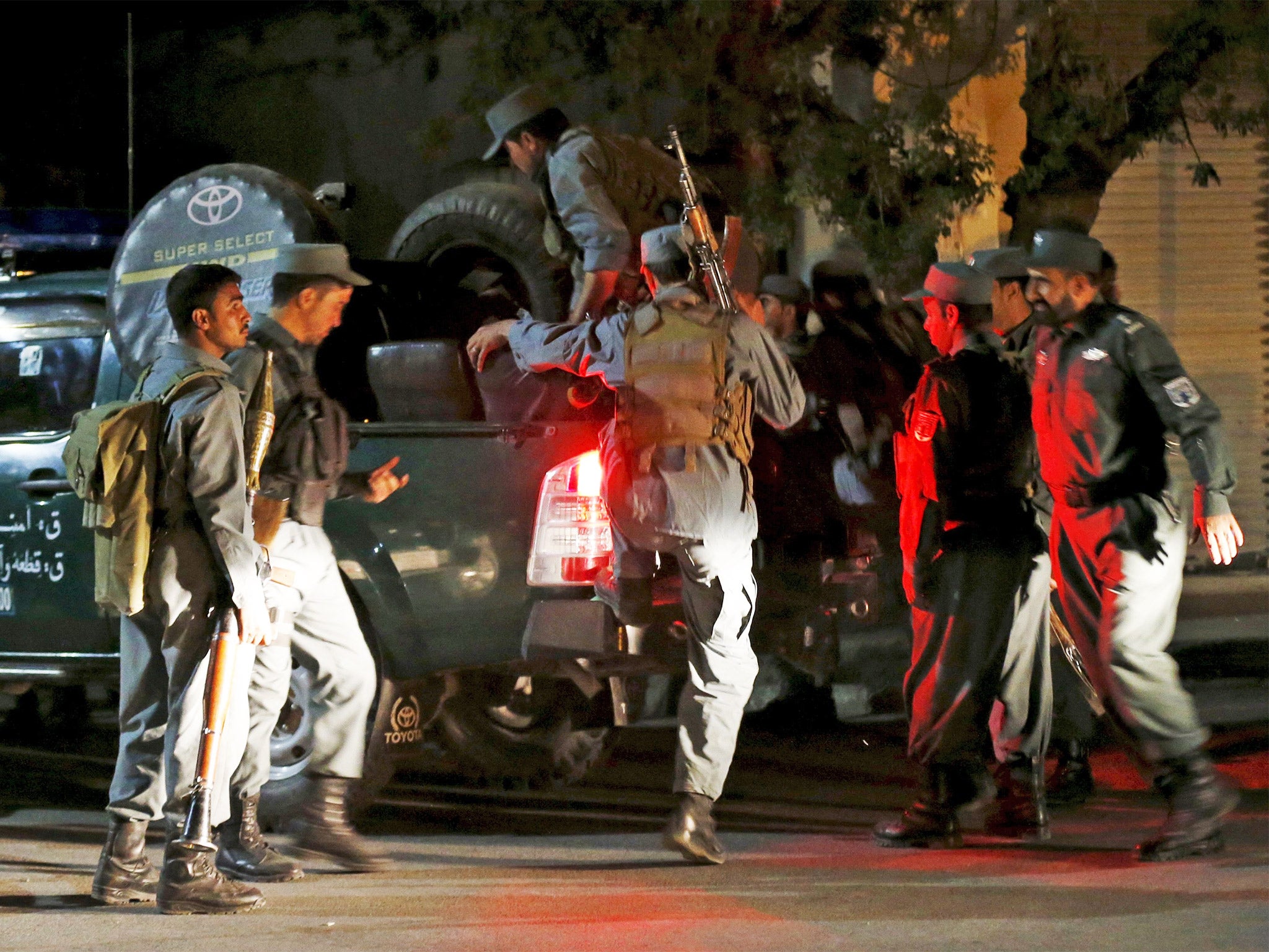 Afghan policemen arrive near the site of an attack in Kabul