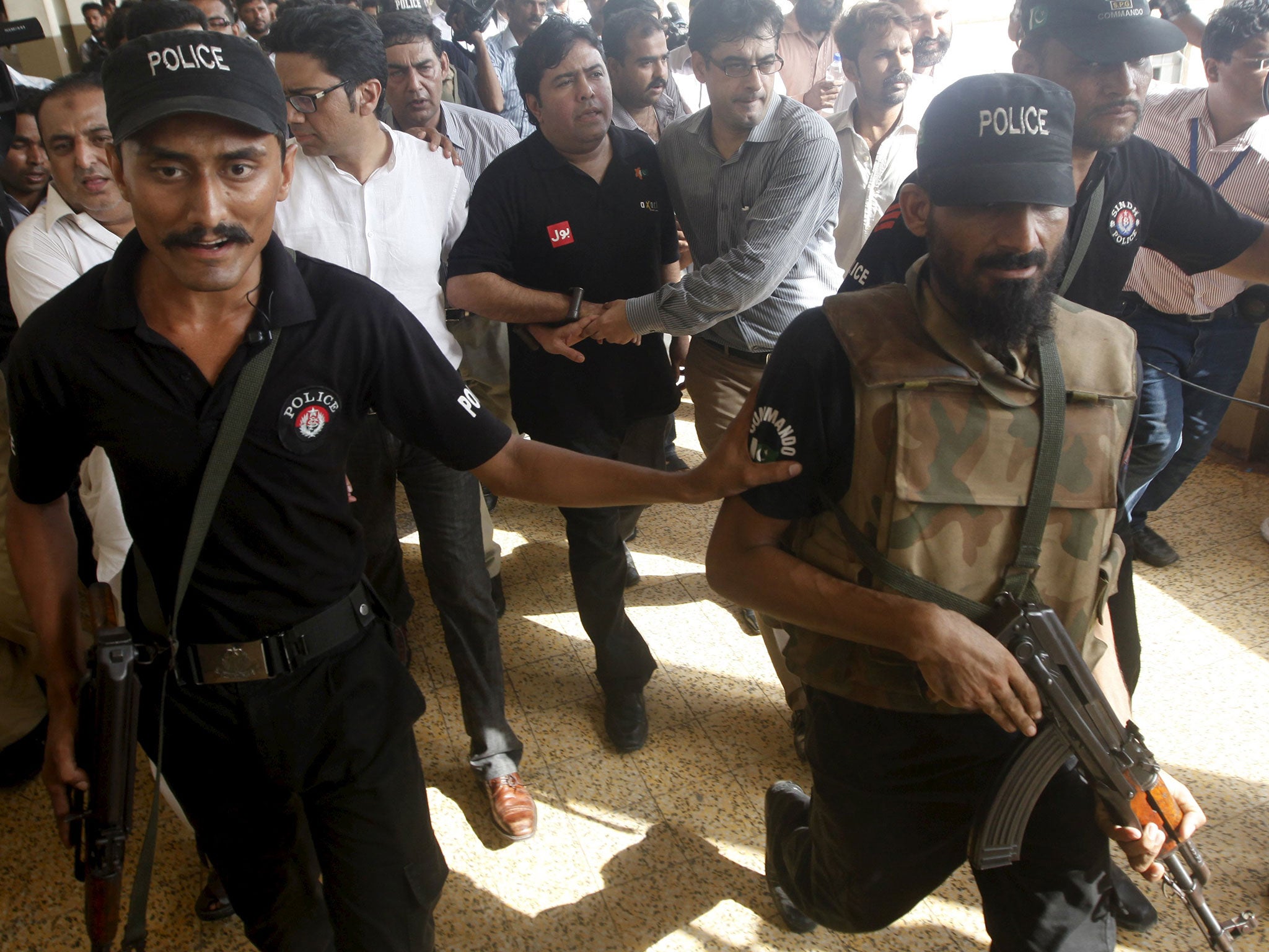 Shoaib Ahmed Shaikh, centre, was arrested in Karachi