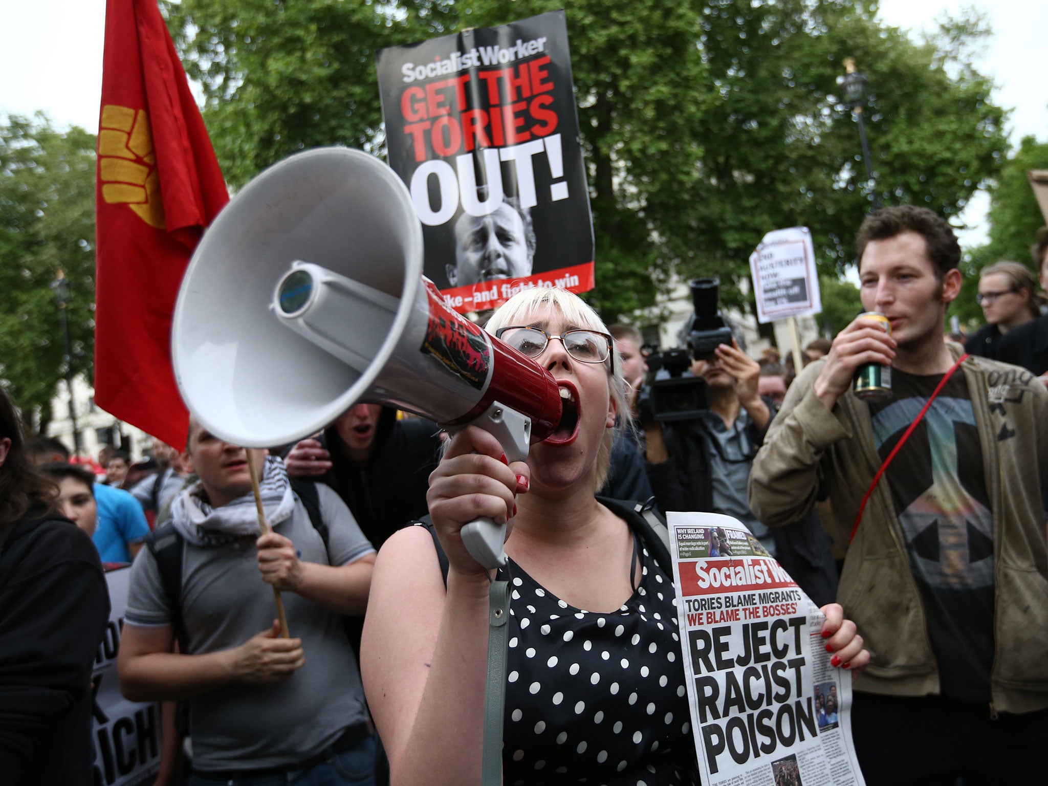 A protester shouts into a megaphone during an anti-austerity protest in London