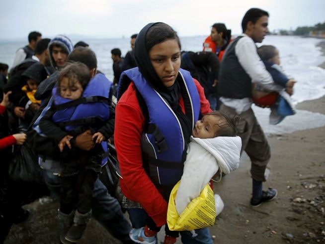 Afghan immigrants land at a beach in Kos after landing in a dinghy on 27 May