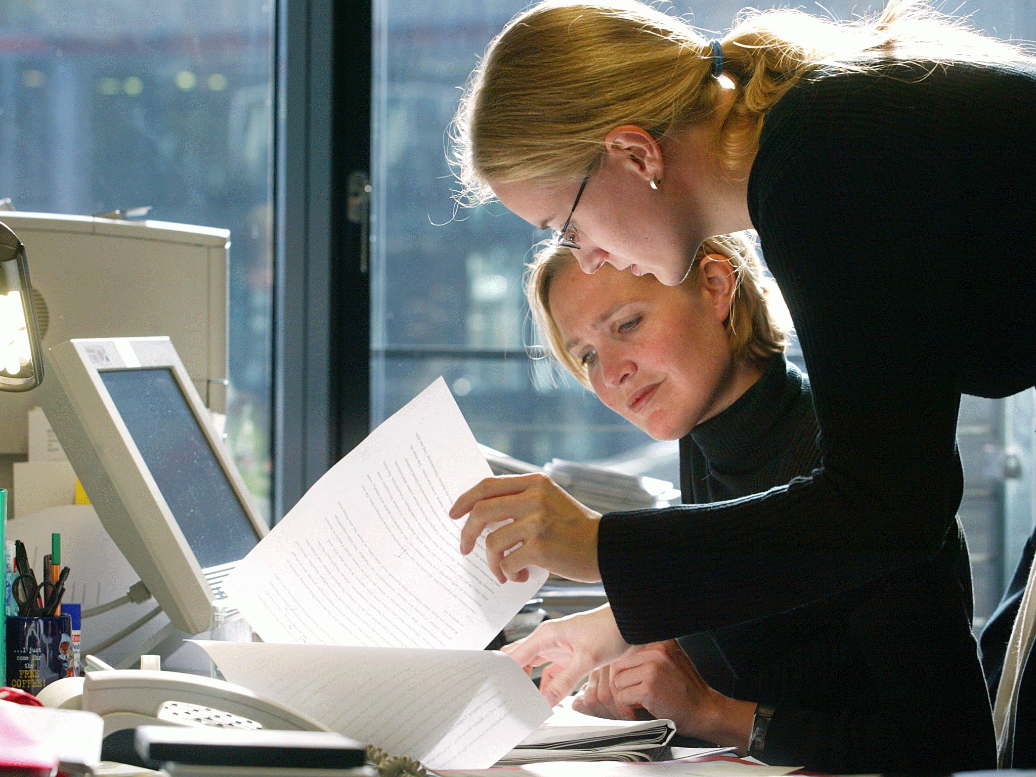 Employees of EnBW, an EDF subsidiary in Berlin, work at their desk 13 October 2003