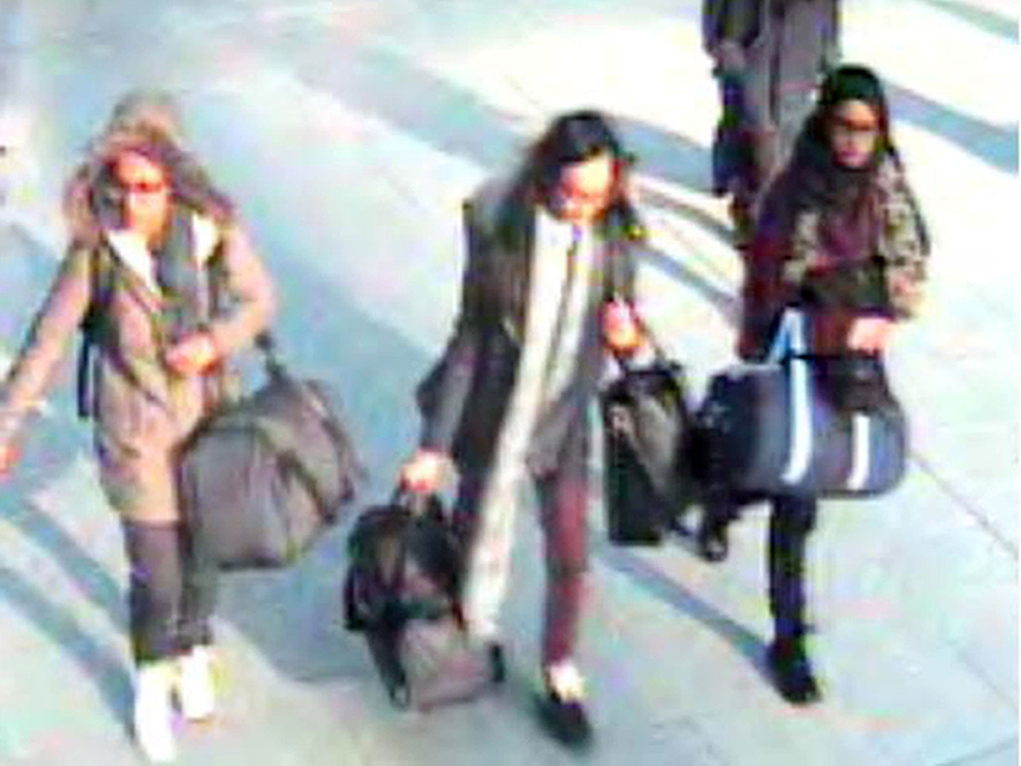 Amira Abase, left, Kadiza Sultana and Shamima Begum walk through Gatwick airport