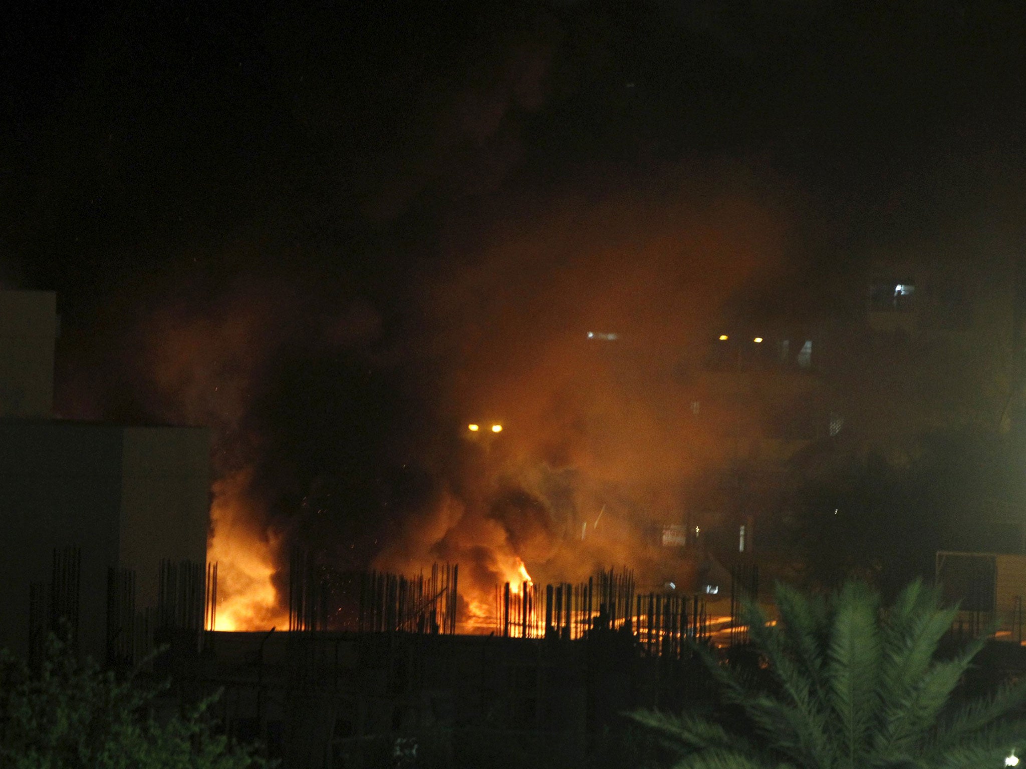 Car bombs exploded in the parking lots of two heavily fortified five-star hotels in central Baghdad, killing at least 10 people