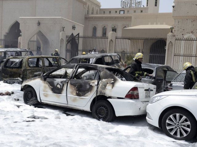 Firefighters at the scene of the bombing after putting the blaze out using foam