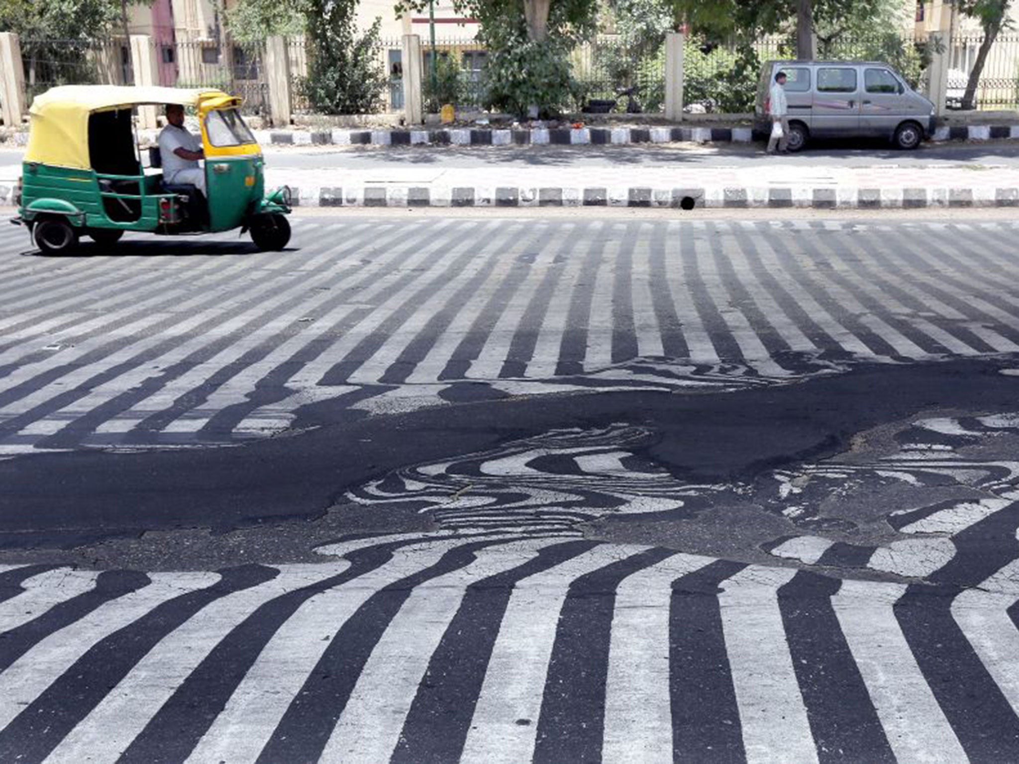 A zebra crossing distorts as the asphalt melts in New Delhi