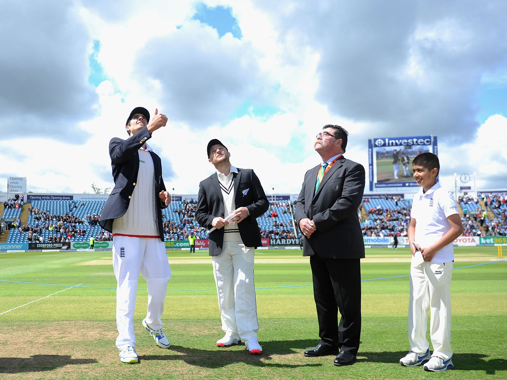 England captain Alastair Cook tosses the coin alongside Brendon McCullum