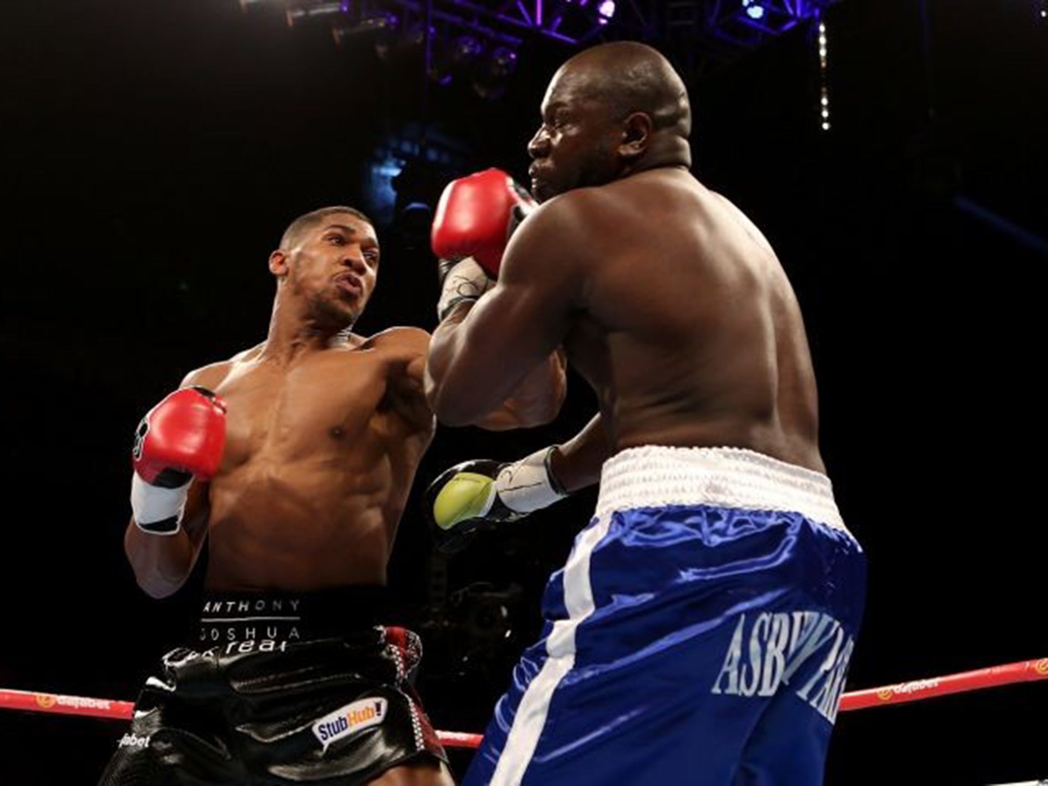 Anthony Joshua of England and Kevin Johnson of The USA exchange blows during their WBC International Heavyweight bout at The O2 Arena.