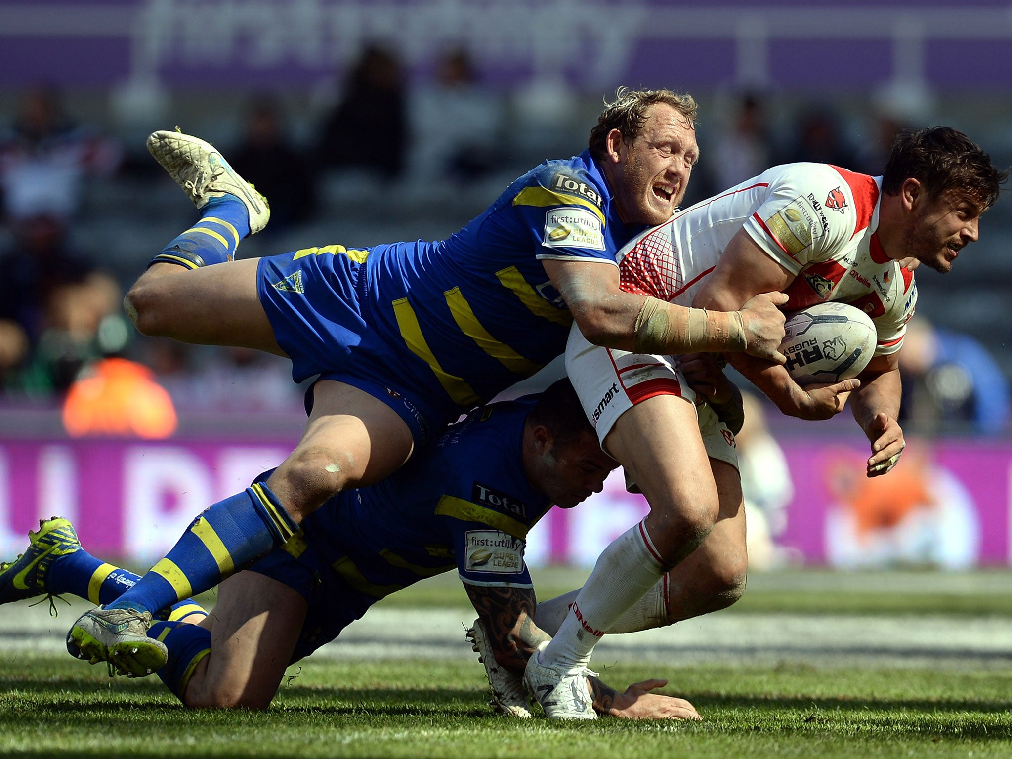 St Helens’ match-winner Jon Wilkin is tackled by Ben Westwood and Chris Bridge of Warrington