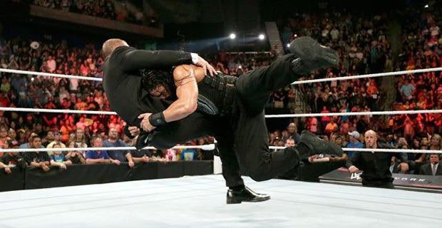 Reigns spears Triple H after the match