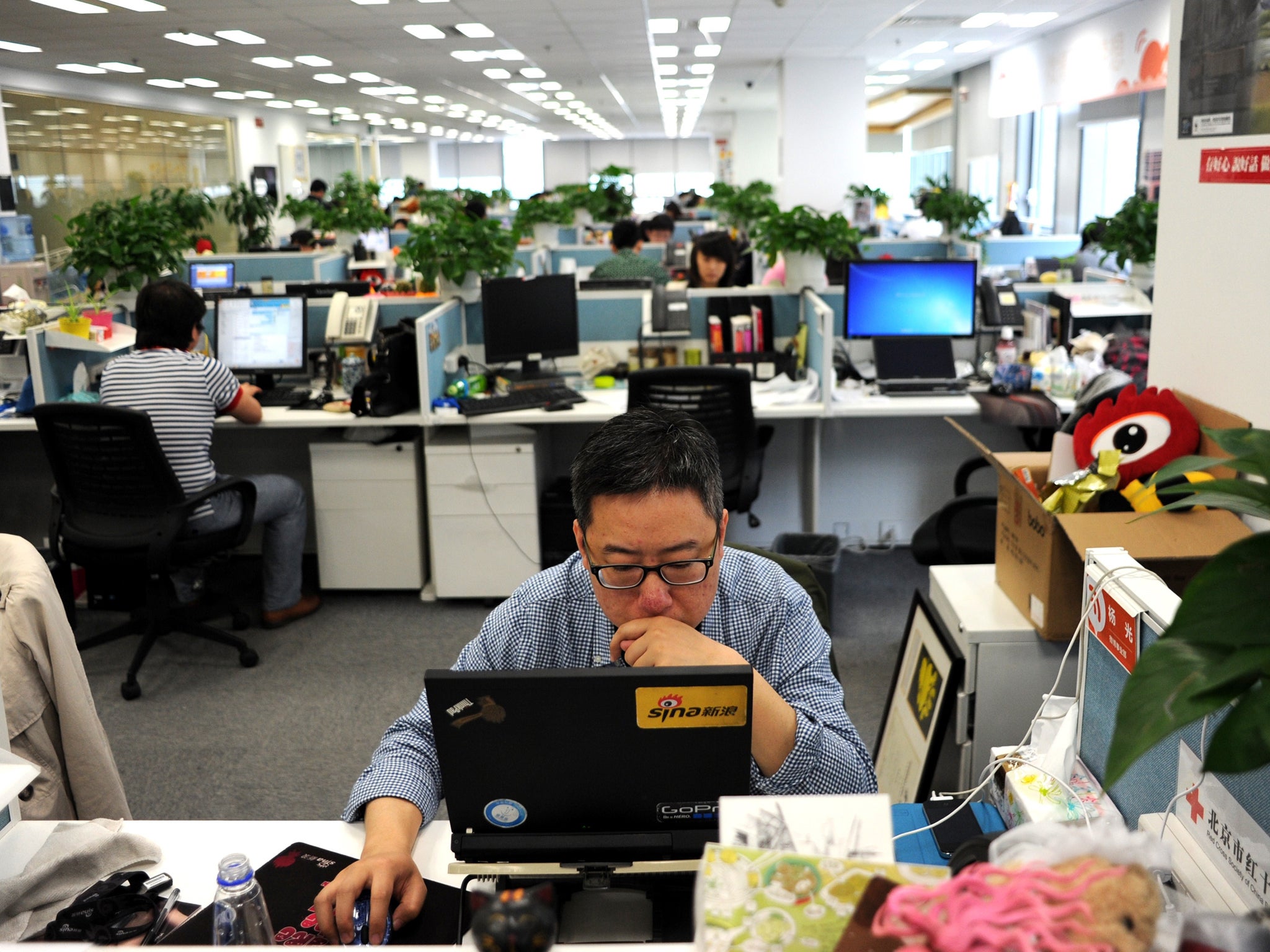 This picture taken on April 16, 2014 shows a man using a laptop at an office of Sina Weibo, widely known as China's version of Twitter, in Beijing