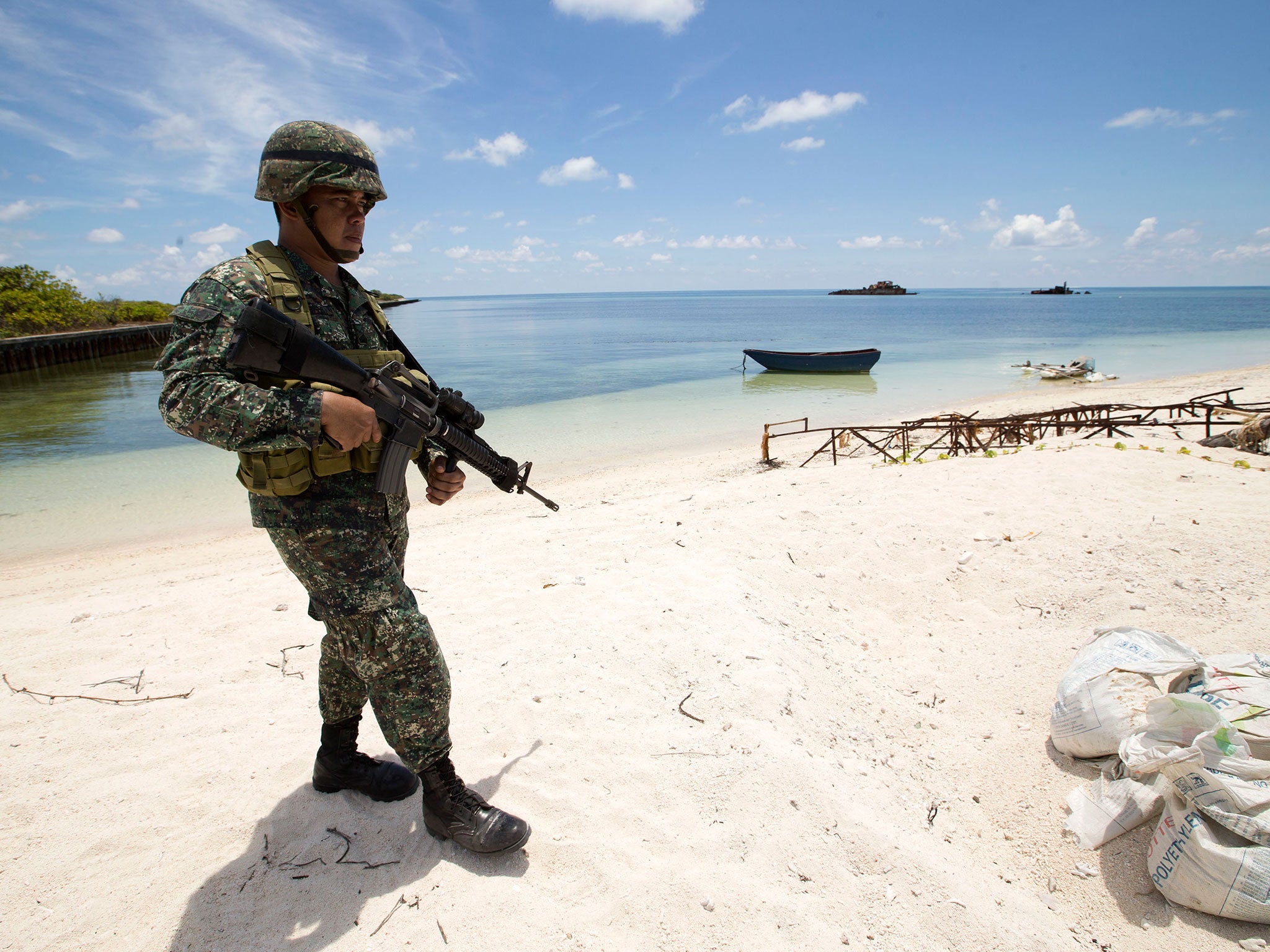 &#13;
A Filipino soldier on patrol on Pagasa, one of the Spratly Islands. Tension in the region is growing because of China’s alleged plans to station military aircraft on some of the islands &#13;