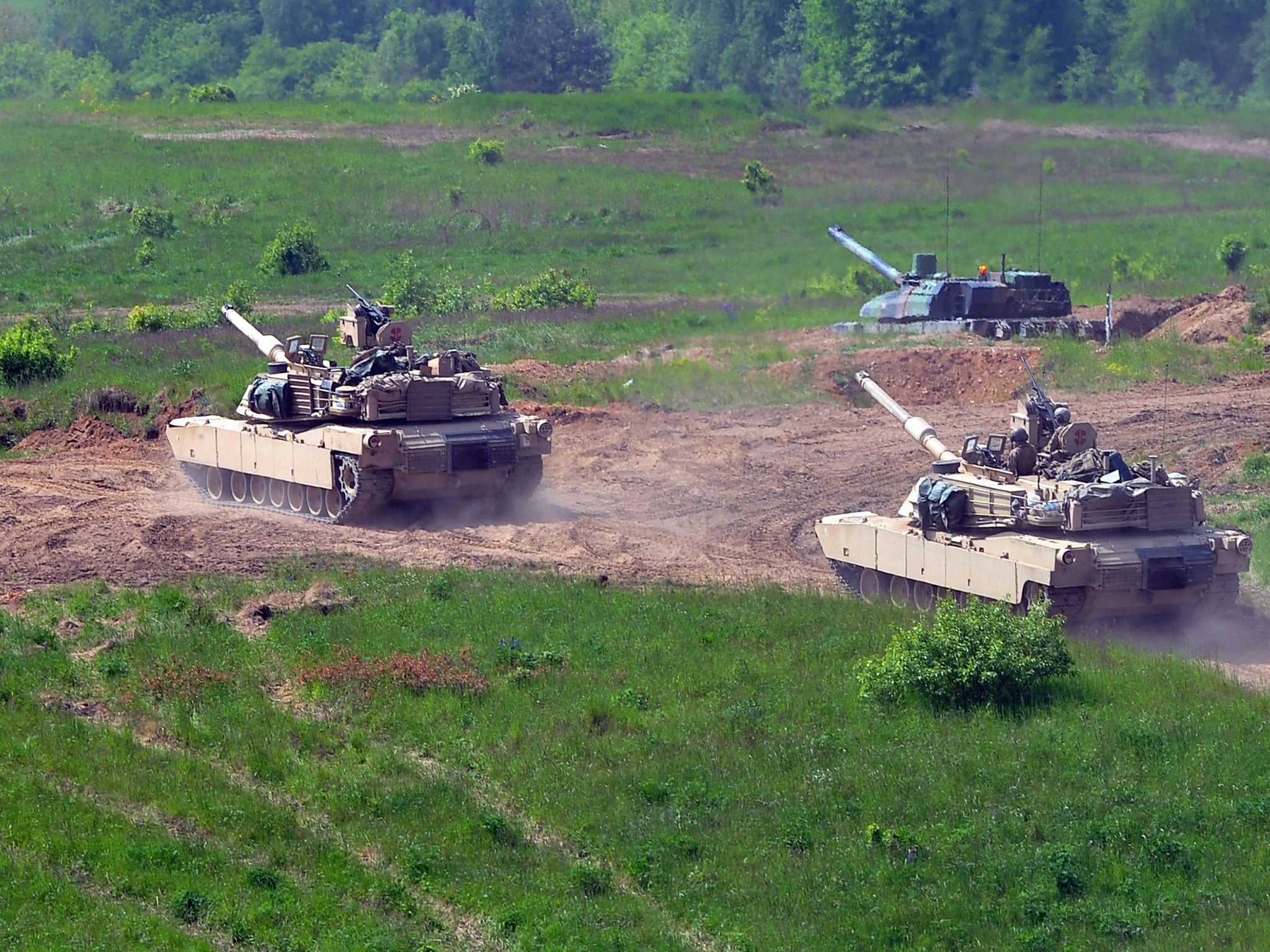 US M1 Abrams battle tanks (front) and French Leclerc tank (back) during the Nato military exercises in Drawsko Pomorskie, Poland, on 29 May 2015