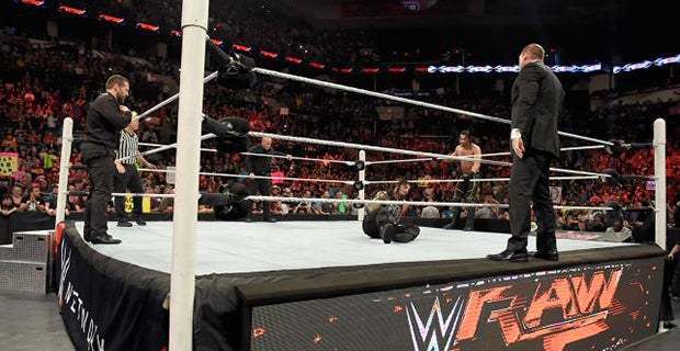 The Authority surround Reigns in the ring