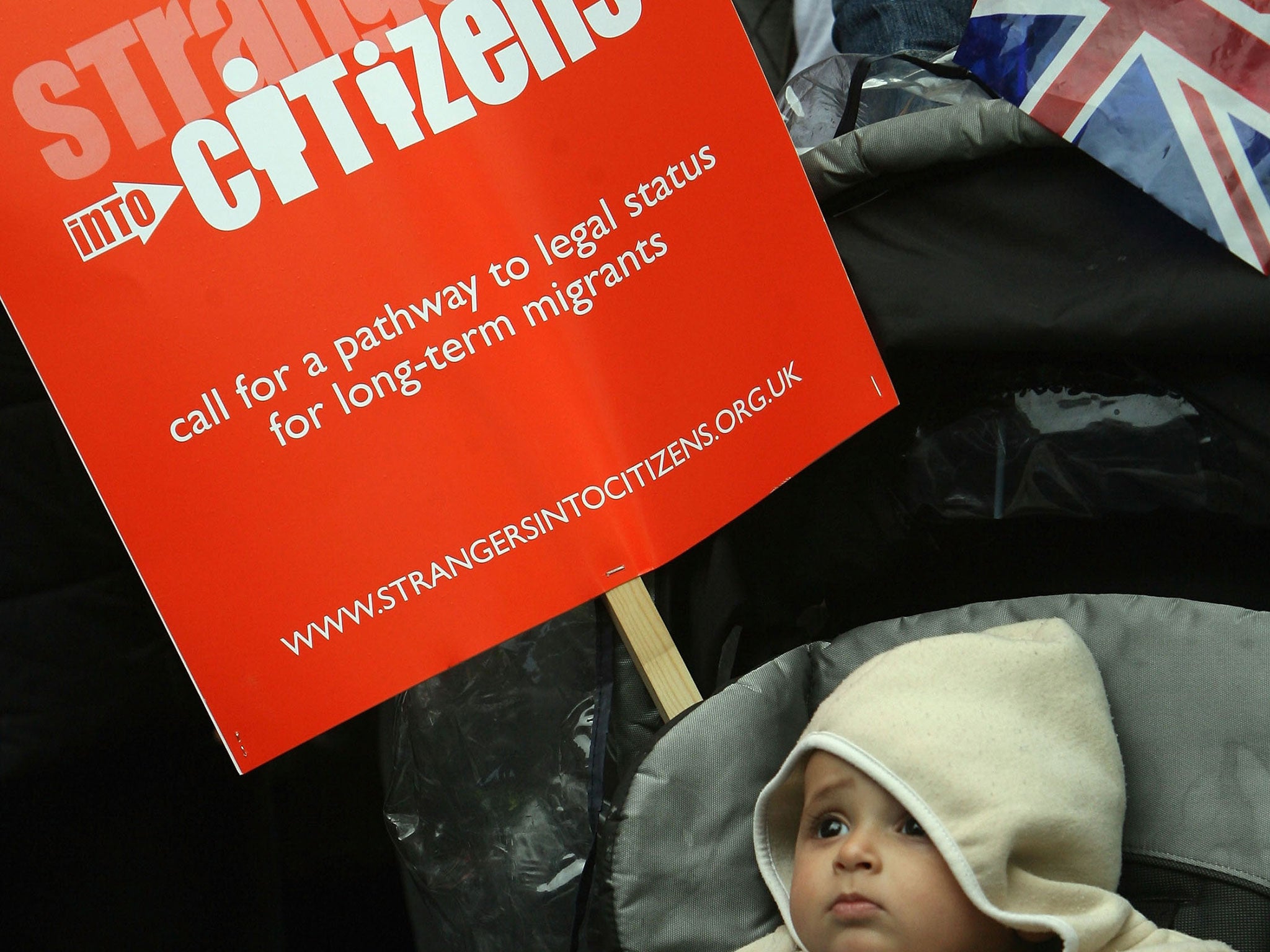 A child at a rally protesting for more rights for migrants